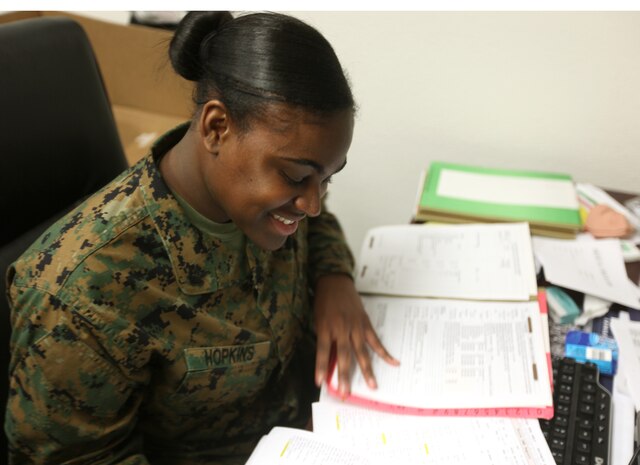 Petty Officer 2nd Class Yeishia R. Hopkins, a corpsman with the Combined Aid Station, 2nd Marine Logistics Group (Forward), reviews medical records to ensure the Marines are up to date with their shots aboard Camp Lejeune, N.C., Jan. 26, 2010.  The corpsmen at the CAS have the arduous task of keeping track of medical records, making sure the Marines and sailors are up to date with their vaccines and ensuring the Group is ready to deploy. (U.S. Marine Corps photo by Lance Cpl. Bruno J. Bego)