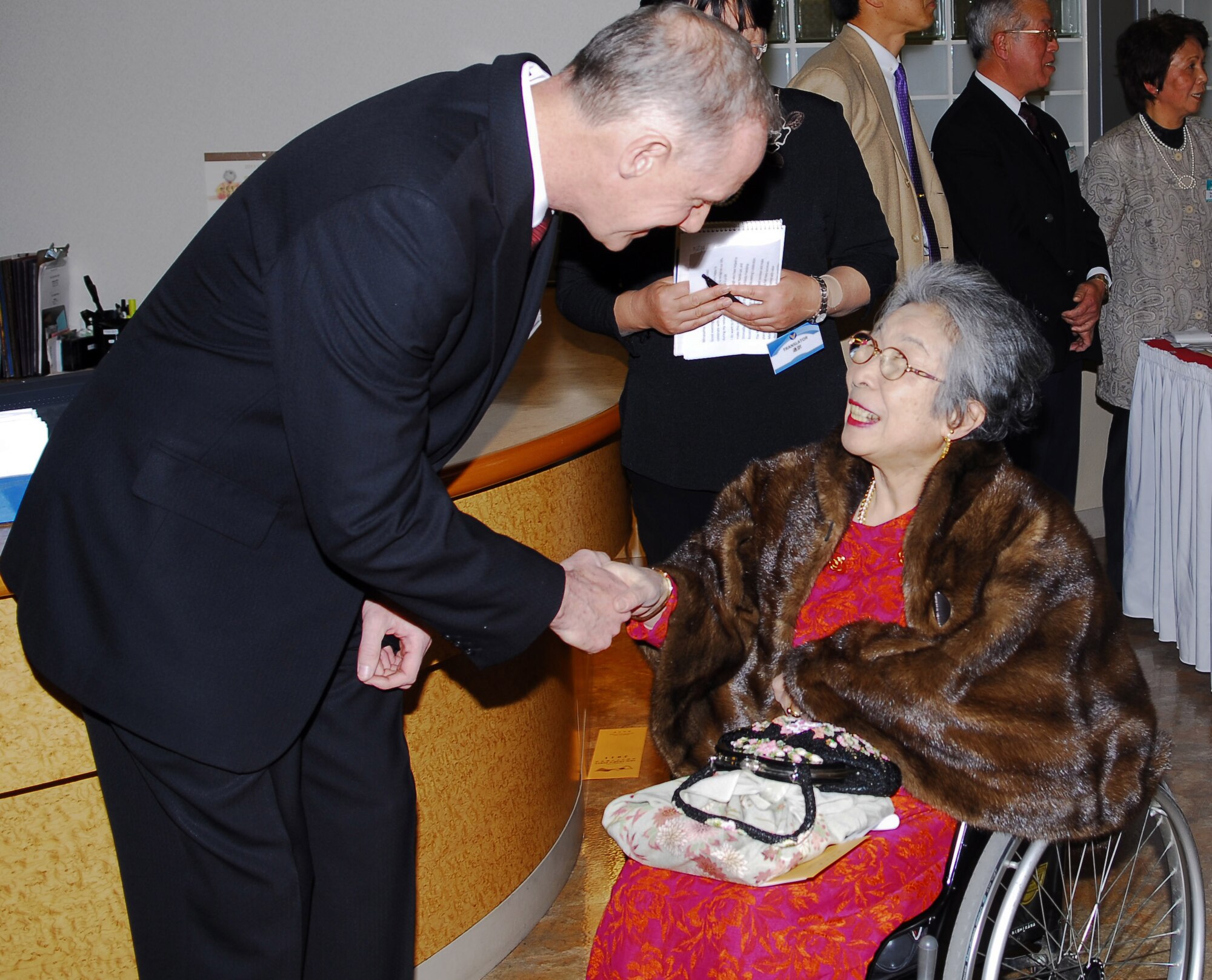 YOKOTA AIR BASE, Japan -- Col. Otto Feather, 374th Airlift Wing commander, greets Chieko Nishikawa, a member of Akishima-Yokota Friendship Club, at the Joint New Year's Party held at the Enlisted Club for the local friendship clubs here Jan. 23. Team Yokota hosts events like this for members of the community to help strengthen U.S. and Japanese relations. (U.S. Air Force photo/Airman 1st Class Lynsie Nichols)
