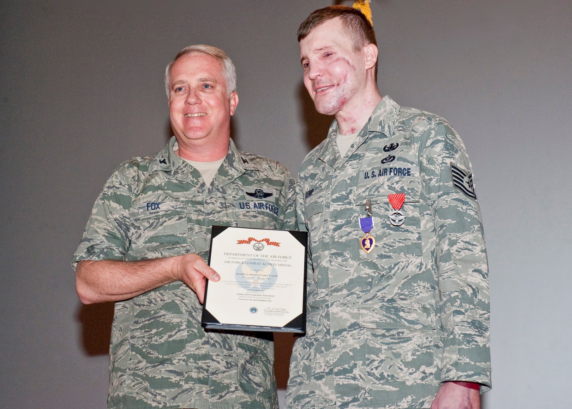 NELLIS AIR FORCE BASE, Nev.-- Col. Kevin Fox, 99th Mission Support Group commander, presents the Air Force Combat Action Medal to Tech. Sgt. Cory Kemp, 99th Civil Engineer Squadron explosive ordnance disposal technician, for his honorable service during Operation Enduring Freedom. The Combat Action Medal is awarded to Airmen who have been involved in direct fighting situations where they risked their lives in an enemy engagement. In addition, Sergeant Kemp received the Purple Heart, awarded to members of the U.S. military who are wounded by an enemy during combat operations. Sergeant Kemp sustained injuries from an improvised explosive device detonation in Kandahar, Afghanistan, in September. (U.S. Air Force photo by Airman 1st Class Jamie Nicley)
