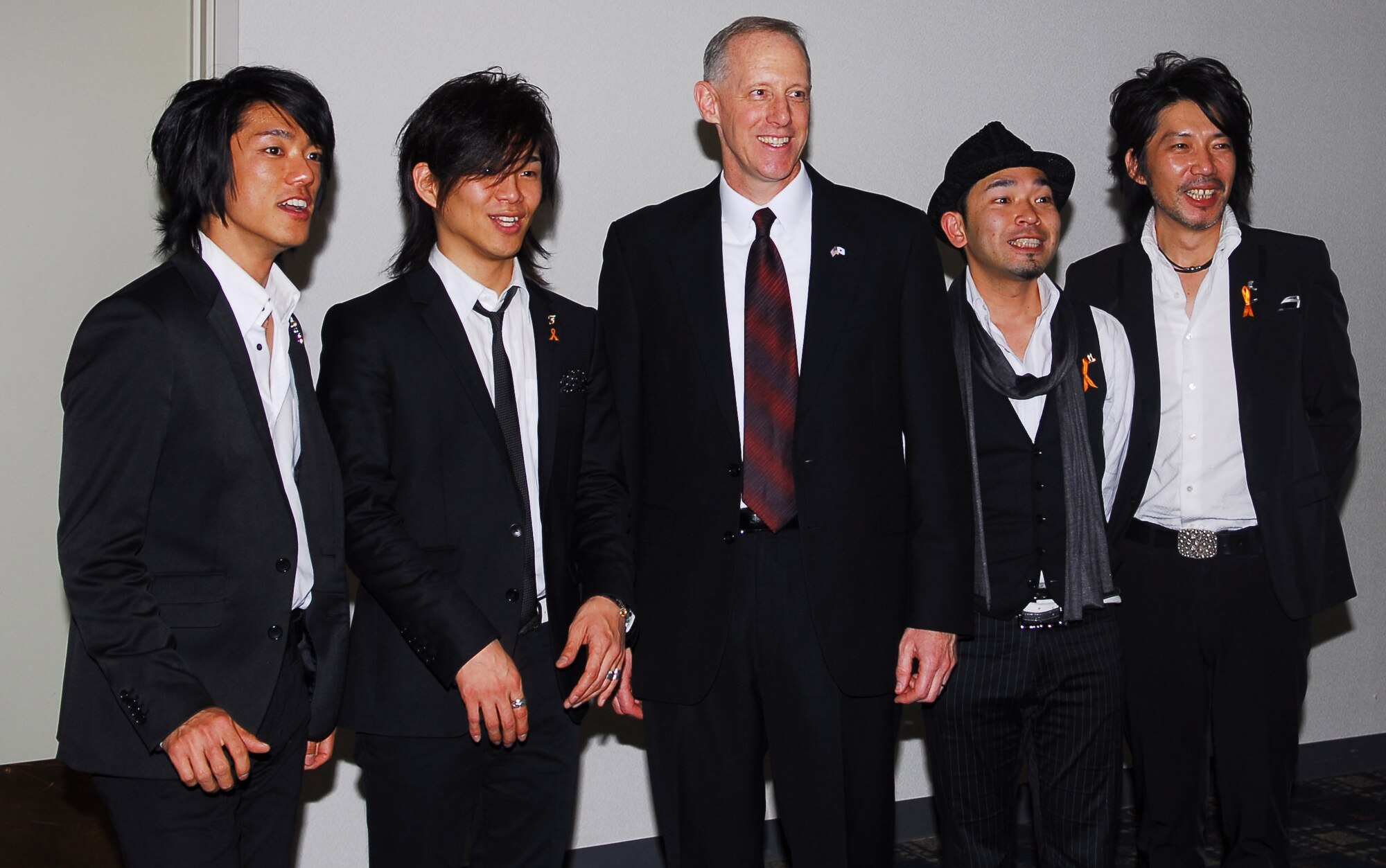 YOKOTA AIR BASE, Japan – (Middle) Col. Otto Feather, 374th Airlift Wing commander, poses with members from Voxray, a local Japanese band, after their performance at the Joint New Year's Party held at the Enlisted Club here Jan. 23. (U.S. Air Force photo/Airman 1st Class Lynsie Nichols)