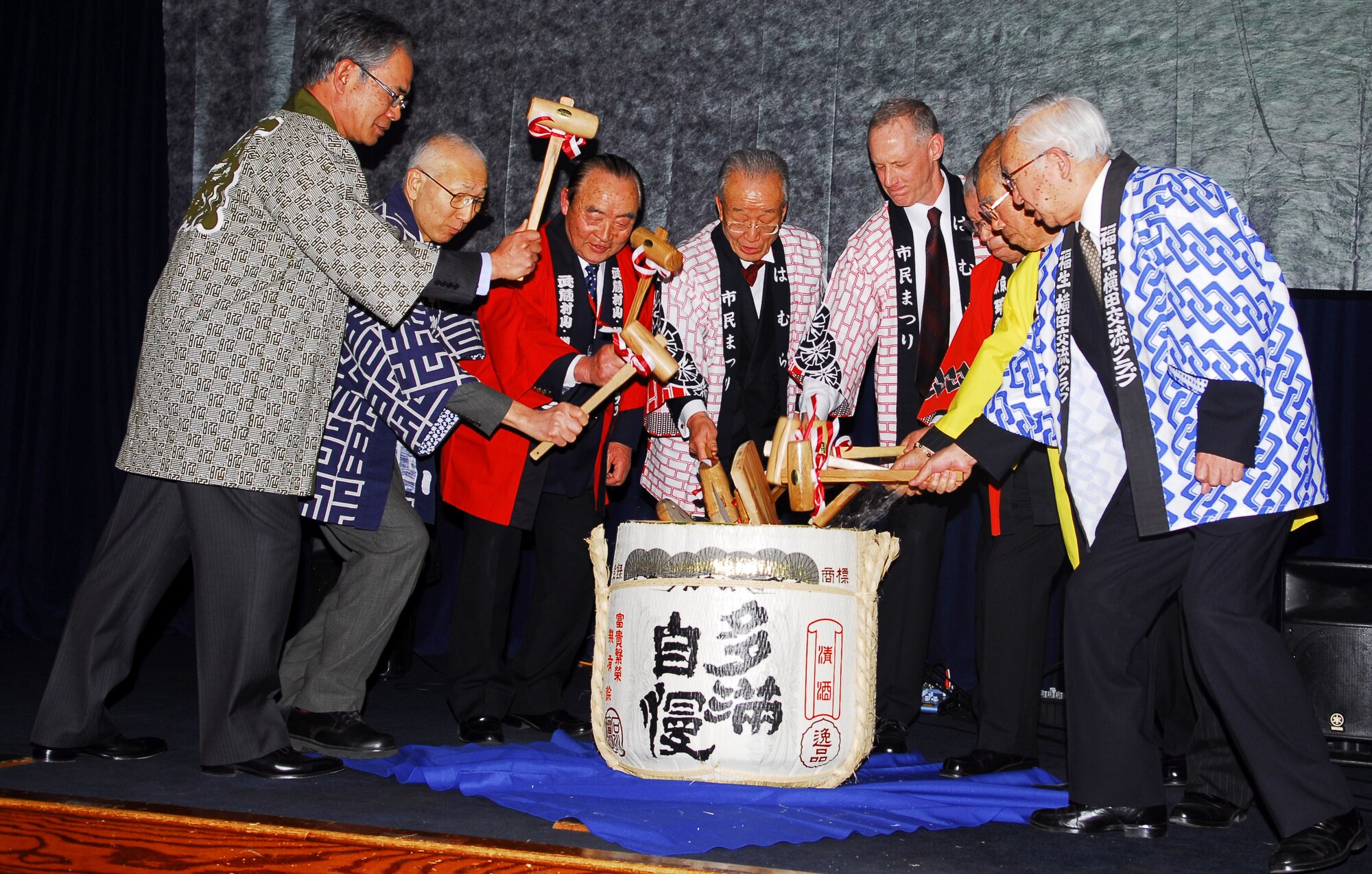 YOKOTA AIR BASE, Japan -- (Middle right) Col. Otto Feather, 374th Airlift Wing commander, along with several friendship club presidents participate in the traditional breaking of the sake cake at the Joint New Year's Party here Jan. 23. Team Yokota hosts events like this for members of the community to help strengthen U.S. and Japanese relations and to thank local organizations for their support during the year. (U.S. Air Force photo/Airman 1st Class Lynsie Nichols)
