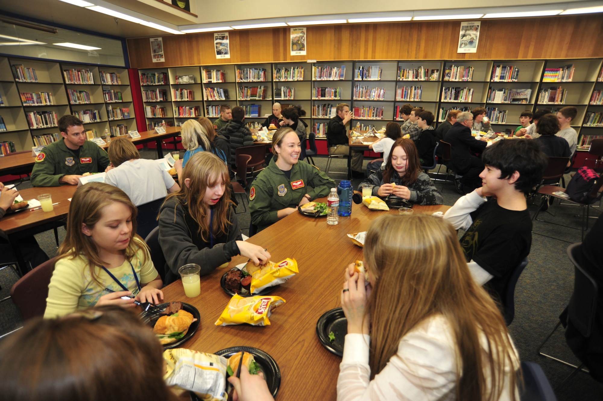 Pilot panel members, including three assigned to McChord Field’s 10th Airlift Squadron, enjoy lunch with seventh and eighth grade students after participating in the annual pilot panel at Key Peninsula Middle School Jan. 24 in Lakebay, Wash. The students spoke with civilian and military pilots about their career fields. (U.S. Air Force photo/Airman Leah Young)