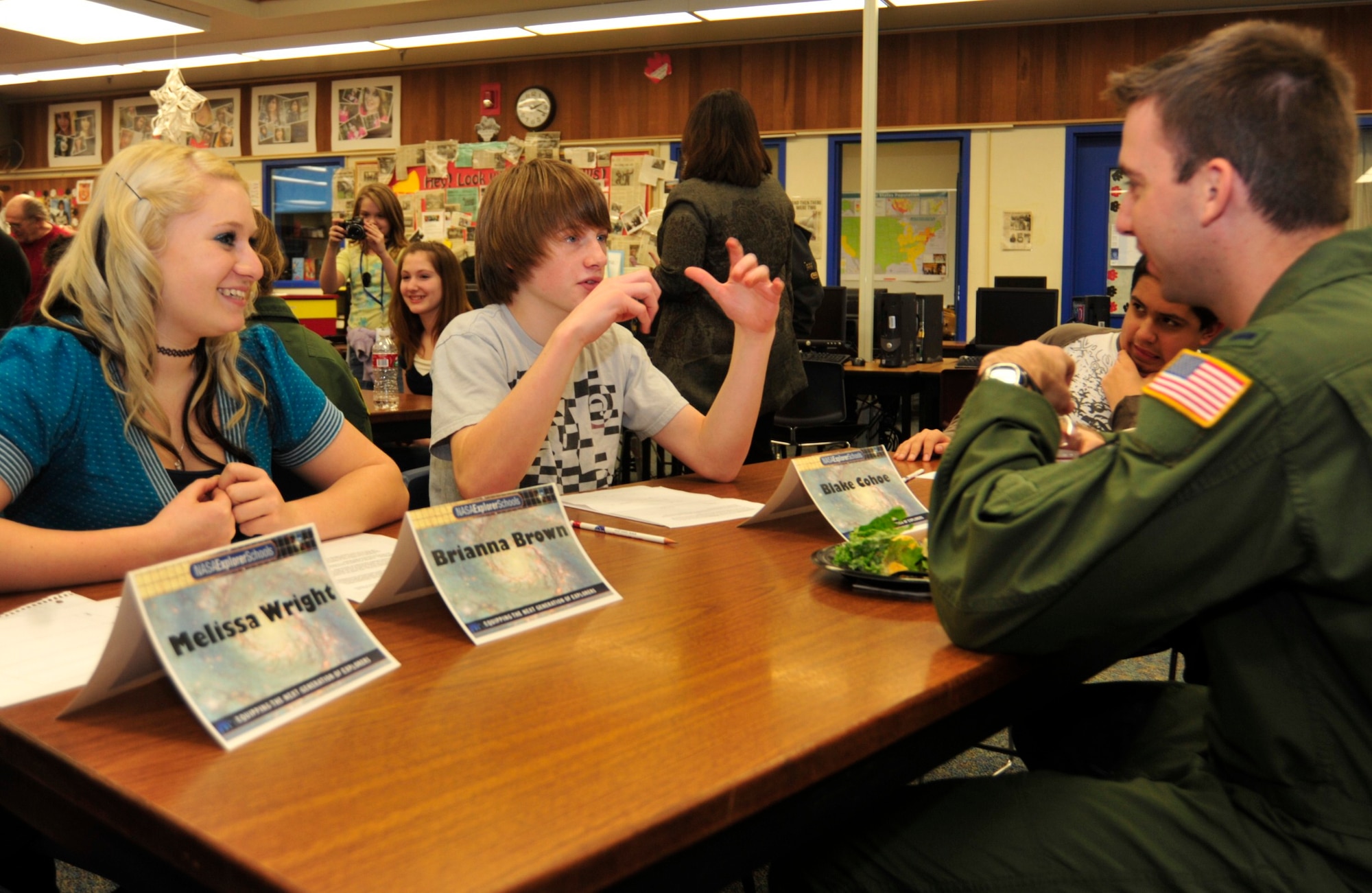 Brianna Brown, 12, left, and Blake Cohoe, 12, center, both seventh grade students enrolled in the Astronomy and Aerospace course at Key Peninsula Middle School, speak to Capt. Dustin Dere, right, 10th Airlift Squadron pilot, Jan. 24 about joining the Air Force and then obtaining medical degrees. (U.S. Air Force photo/Airman Leah Young)