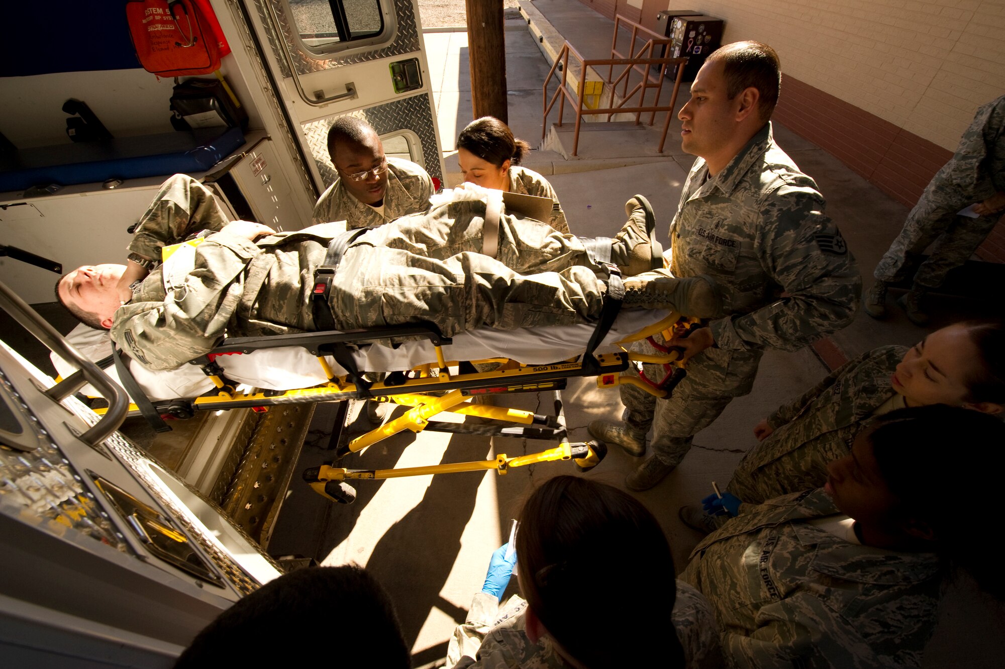 HOLLOMAN AIR FORCE BASE, N.M. -- Staff Sgt. Adrian Estrada, 49th Medical Operations Squadron, loads Senior Airman J Otto, 49th MDOS, into an ambulance at the medical clinic during an exercise Jan. 22, 2011. The exercise brought interaction between the 49th Medical Group and 49th Security Forces Squadron, to test initial actions, communications and follow-on response between the two. (U.S. Air Force photo by Airman 1st Class Joshua Turner/Released)