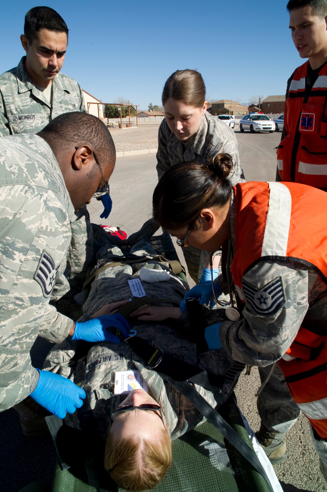 HOLLOMAN AIR FORCE BASE, N.M. -- Members of the 49th Medical Operations Squadron prepare Tech. Sgt. Casey Kalal, 49th MDOS, for transfer to the medical clinic during an exercise Jan. 22, 2011. The exercise brought interaction between the 49th Medical Group and 49th Security Forces Squadron to test initial actions, communications and follow-on response between the two units. This is the first exercise for the 49th MDG during their Saturday training sessions, which began in August. (U.S. Air Force photo by Airman 1st Class Joshua Turner/Released)