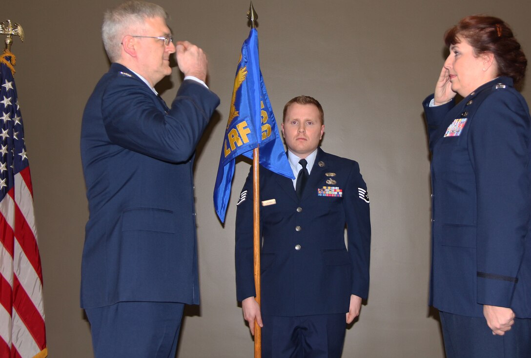 Capt. Wendy Hendley (right) salutes Col. Lynn Jobes, commander of the 932nd Mission Support Group, prior to assuming command of the 932nd Logistics Readiness Flight.  She became commander in ceremonies held at the 932nd Airlift Wing on Jan. 22.  Her previous assignment was at the 908th Airlift Wing, Maxwell Air Force Base, Ala., where she was chief of performance plans.  Also shown is Staff Sgt. Joseph Wiseman with the unit flag. (U.S. Air Force photo/Tech. Sgt. Dan Oliver)