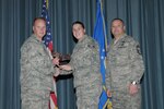 Col. Scott Peel, 902nd Mission Support Group commander, and Chief Master Sgt. Jesus Mireles III, 902nd MSG superintendent, present Senior Airman Shelly Kerstanski, Air Force Personnel Center, with the award for the Airman category, during the Joint Base San Antonio Randolph 4th Quarter Award Ceremony at Randolph Air Force Base, Texas, Jan. 26. (U.S. Air Force photo/Joel Martinez)