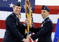 MINOT AIR FORCE BASE, N.D. -- Col. Troy VanBemmelen, 5th Operations Group commander, passes the guidon to Lt. Col. Robert Billings, the new 23rd Bomb Squadron commander, during a change of command ceremony here Jan. 24. (U.S. Air Force photo/Senior Airman Michael J. Veloz)