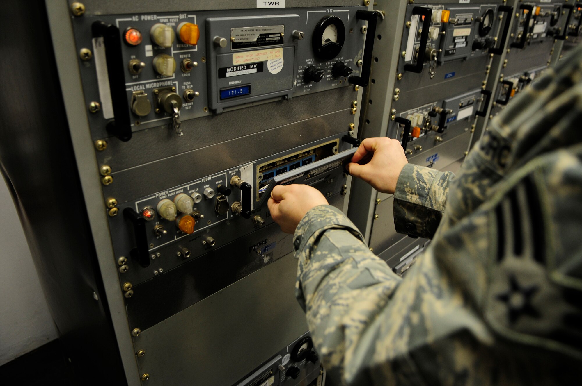 Senior Airman Eric Golden inspects a radio control panel as part of a training lesson Jan. 19, 2011, Eielson Air Force Base, Alaska.  Airman Golden is assigned to the 354th Communications Squadron as an airfield sytems technician.  (Air Force photo by/Airman 1st Class Yash Rojas)