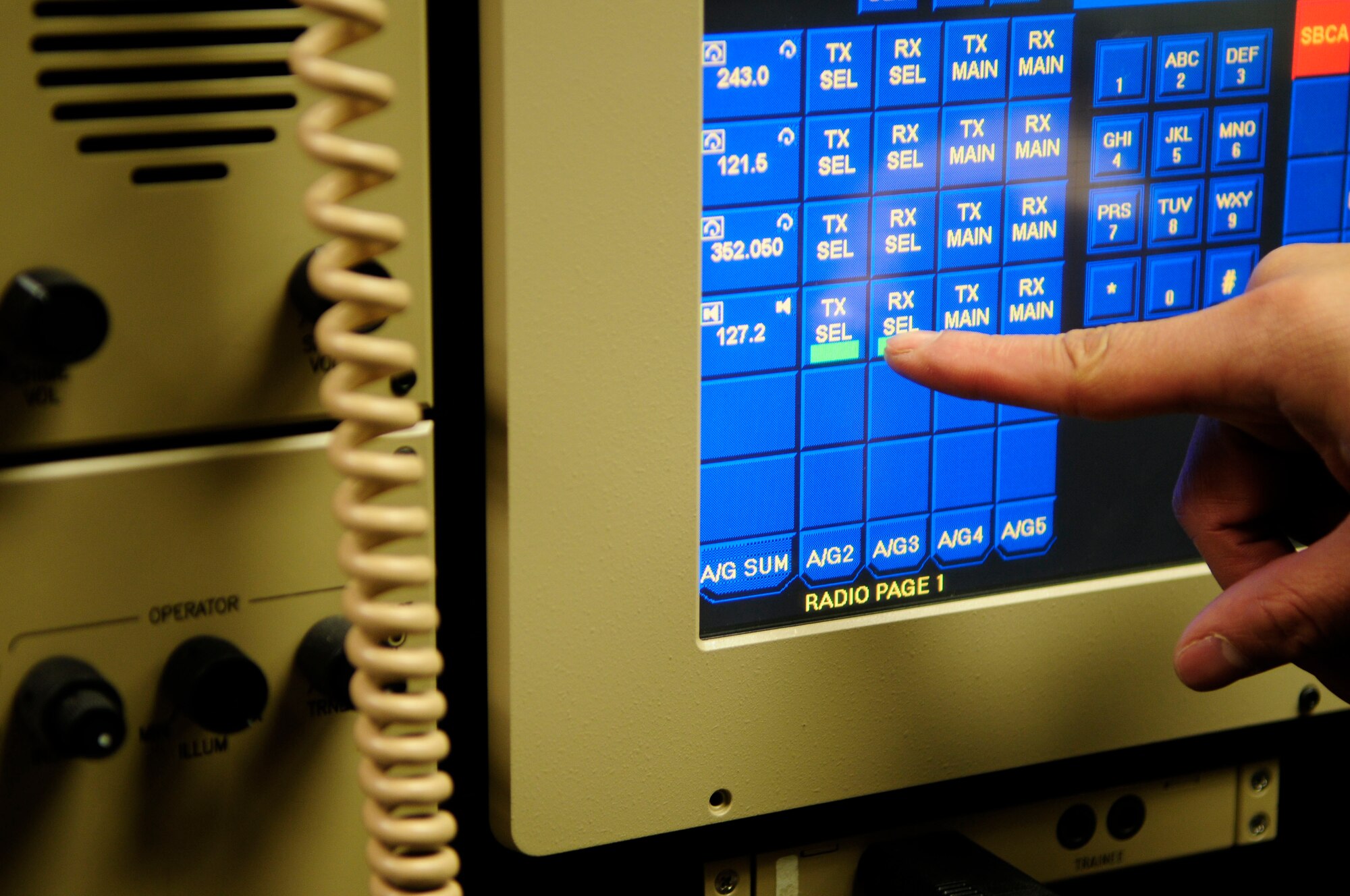 Senior Airman Cory Benton demonstrates features and functions of an enhanced terminal voice switch Jan. 19, 2011, Eielson Air Force Base, Alaska.  The system supports Eielson's communications hub with the ability to transmit safety alerts to the entire base if necessary.  Airman Benton is assigned to the 354th Communications Squadron as an airfield sytems technician.  (Air Force photo by/Airman 1st Class Yash Rojas)