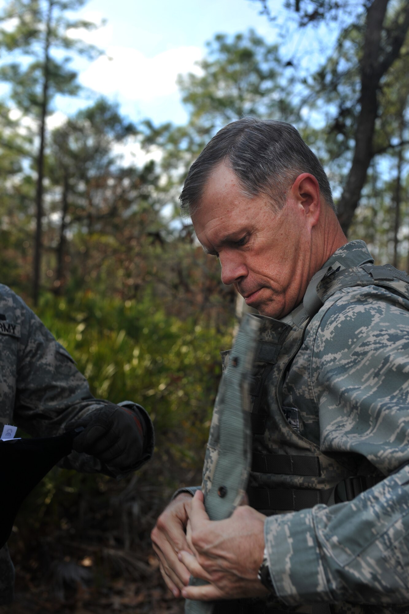 CAMP BLANDING, Fla. -- Gen. William M. Fraser III, commander of Air Combat Command, puts on a flak vest while preparing to participate in a ground combat training course Jan. 24. General Fraser visited Camp Blanding to get a first-hand look at the qualification training course for battlefield weather Airmen. (U.S. Air Force photo/Airman 1st Class Joshua Green)
