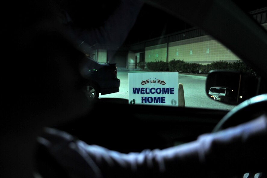MOODY AIR FORCE BASE, Ga.-- Airman 1st Class Brigitte Brantley-Sisk, 23rd Wing Public Affairs journalist, drives by a welcome home sign while pulling up to her husband’s squadron for his homecoming Jan. 12. The newly married couple has been separated for five months, the first time since their nuptials. (U.S. Air Force photo/Airman 1st Class Joshua Green)(RELEASED)
