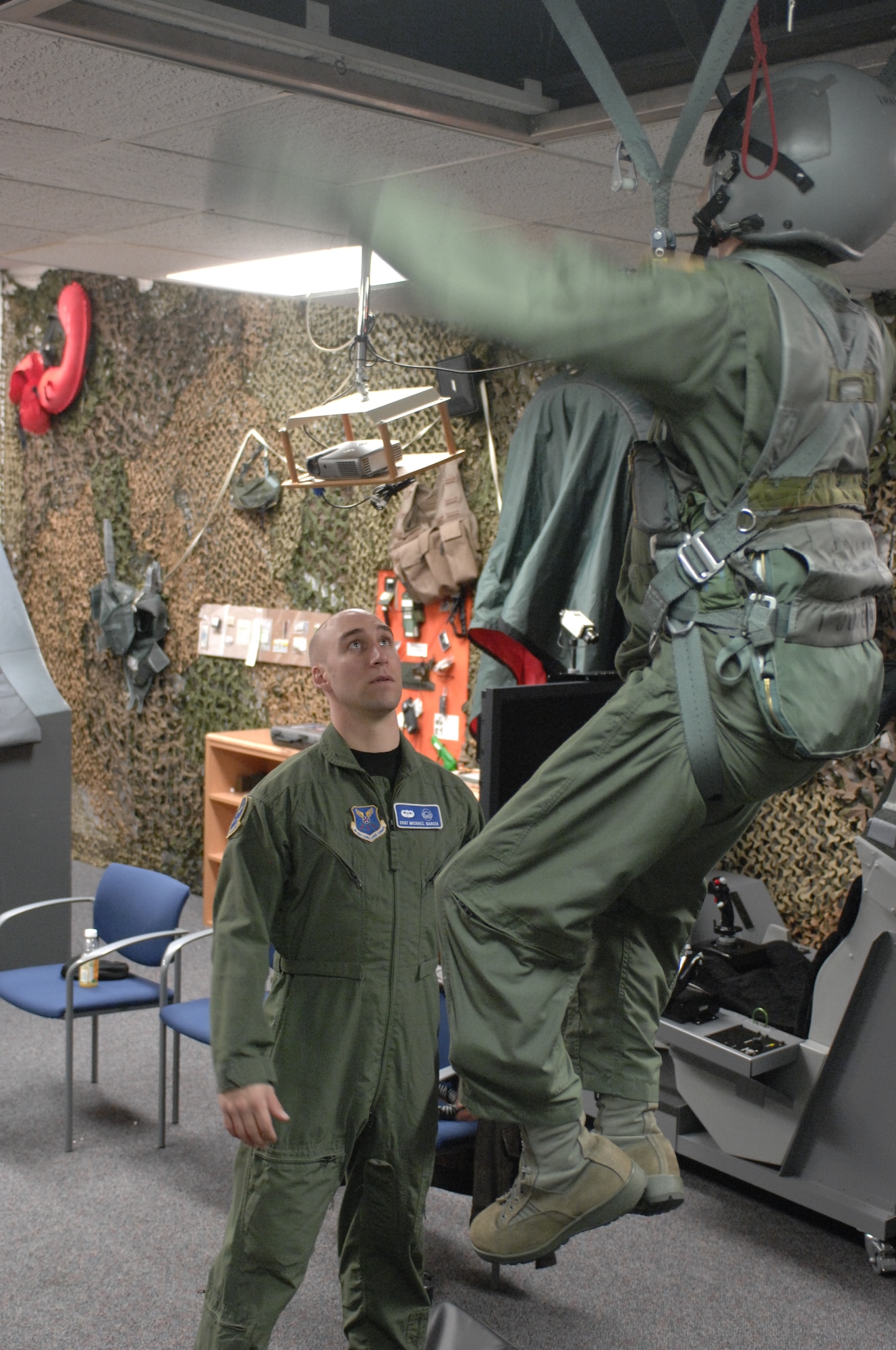 WHITEMAN AIR FORCE BASE, Mo. -- Staff Sgt. Michael Garcia, 509th Operation Support Squadron, survival evasion resistance escape specialist, instructs Capt. Adam Goodpasture on post ejection parachute procedures during his SERE training Jan. 25. (U.S. Air Force photo by Airman 1st Class Montserrat Ramirez) (Released)