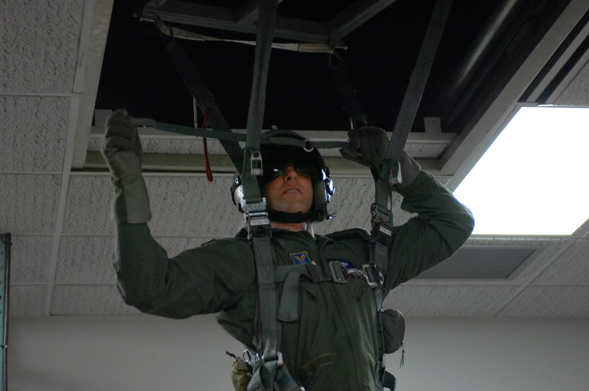 WHITEMAN AIR FORCE BASE, Mo. – Capt. Brian Palmer, 393rd Bomb Squadron, attempting to connect his personnel lowering device to his parachute risers.  The PLD is used to safely lower suspended aircrew from dangerous elevations. If used improperly, the aircrew could suffer a fatal fall.  (U.S. Air Force photo by Airman 1st Class Montserrat Ramirez) (Released)