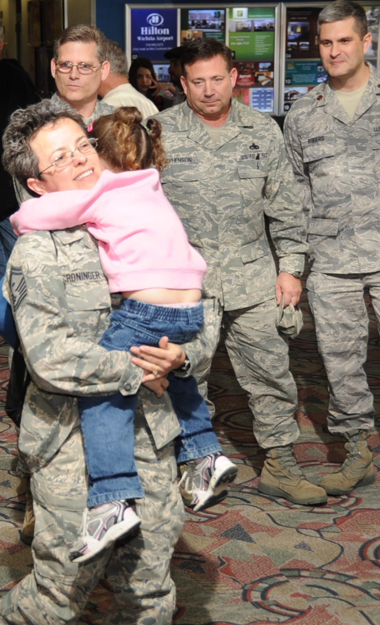 Senior Master Sgt. Sheila Croninger, a first sergeant with the 931st Air Refueling Group greets her daughter with a hug after returning from a deployment in Southwest Asia. Leaders from the 931st ARG came to the airport in Wichita to welcome Sergeant Croninger on as she returned to her family at home and with the 931st ARG.