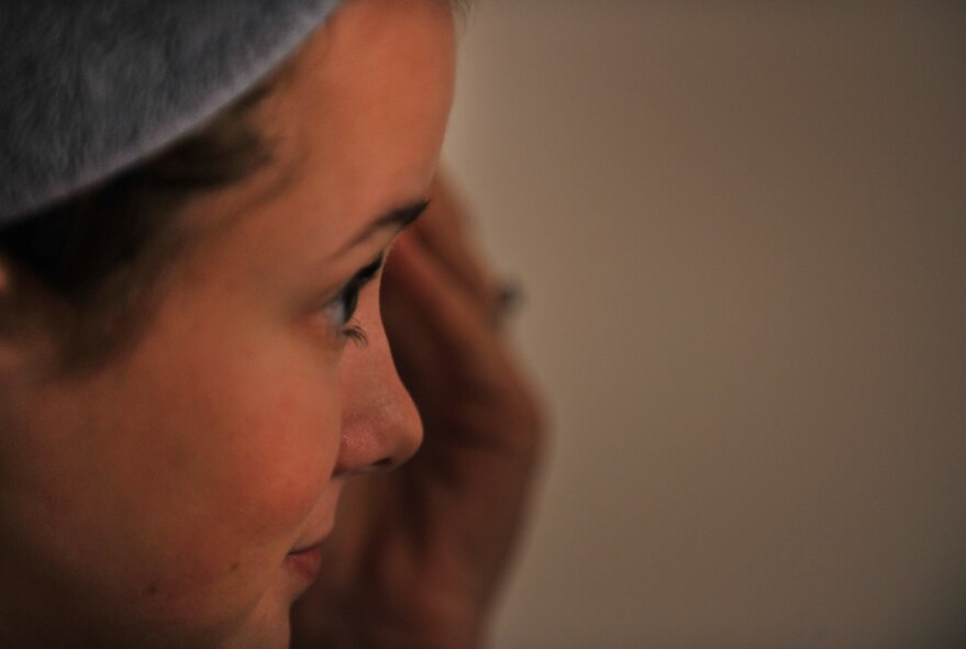 MOODY AIR FORCE BASE, Ga.-- Airman 1st Class Brigitte Brantley-Sisk, 23rd Wing Public Affairs journalist, looks into the mirror while applying eye liner in preparation for the return of her husband Jan. 12. Airman Brantley-Sisk is married to Staff Sgt. Clifford Sisk, 38th Rescue Squadron aircrew flight equipment NCO, who’s been deployed for nearly five months. (U.S. Air Force photo/Airman 1st Class Joshua Green)(RELEASED)
