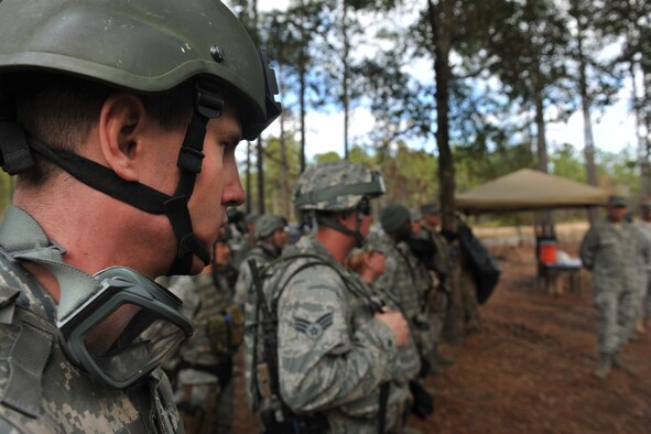 CAMP BLANDING, Fla. -- Senior Airman John Tice, 3rd Weather Squadron battlefield weather Airman at Fort Hood, Texas, looks toward Gen. William M. Fraser III, commander of Air Combat Command, as he gives his closing remarks about the qualification training course for battlefield weather Airmen Jan. 24. (U.S. Air Force photo/Airman 1st Class Joshua Green)