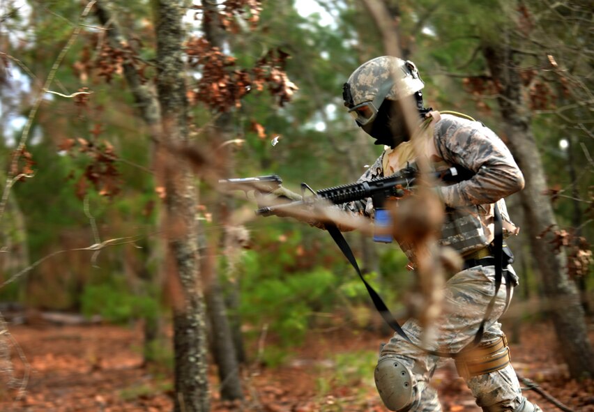 CAMP BLANDING, Fla.-- Maj. Ken Burton, 18th Weather Squadron director of operations at Fort Bragg, N.C., runs through the woods during a ground combat training course Jan. 24. The course is designed to train battlefield weather Airmen to live and work alongside the U.S. Army and receive ground combat training. (U.S. Air Force photo/Airman 1st Class Joshua Green)(RELEASED)
