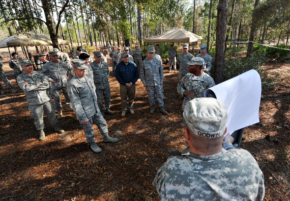 CAMP BLANDING, Fla. -- Army Sgt. 1st Class Edward Stokes, 211st Regiment, Regional Training Institute infantry instructor, explains the course layout to distinguished guests during a visit to Camp Blanding, Fla., Jan. 24. Among those guests was Gen. William M. Fraser III, commander of Air Combat Command, who not only received a brief about the qualification training course for battlefield weather Airmen, but geared up and participated in a portion of it. (U.S. Air Force photo/Airman 1st Class Joshua Green)