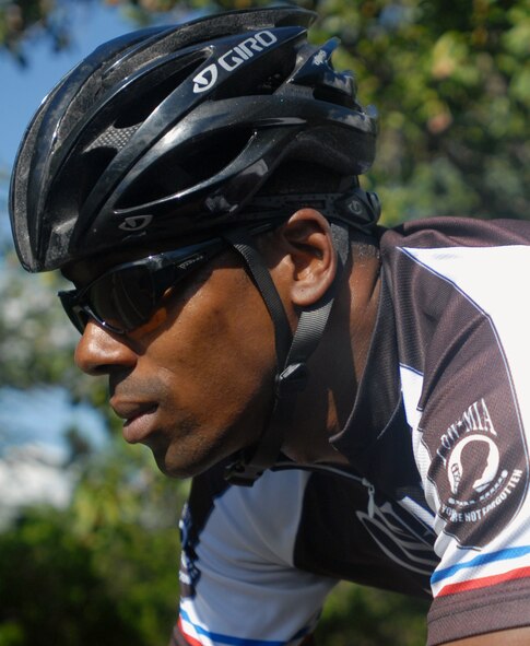 Tech. Sgt. Dwayne Johnson, a 735th Air Mobility Squadron air transportation specialist, rides along the path to Hickam Harbor at Joint Base Pearl Harbor-Hickam, Hawaii, Dec. 22, 2010. His love of cycling inspired him to start Operation iRide, a fund raiser which enabled all of the Airmen E-4 and below in his unit to attend their holiday party free. During the course of one month, Sergeant Johnson biked 1,000 miles and raised $2,020. (U.S. Air Force photo/Staff Sgt. Carolyn Viss)