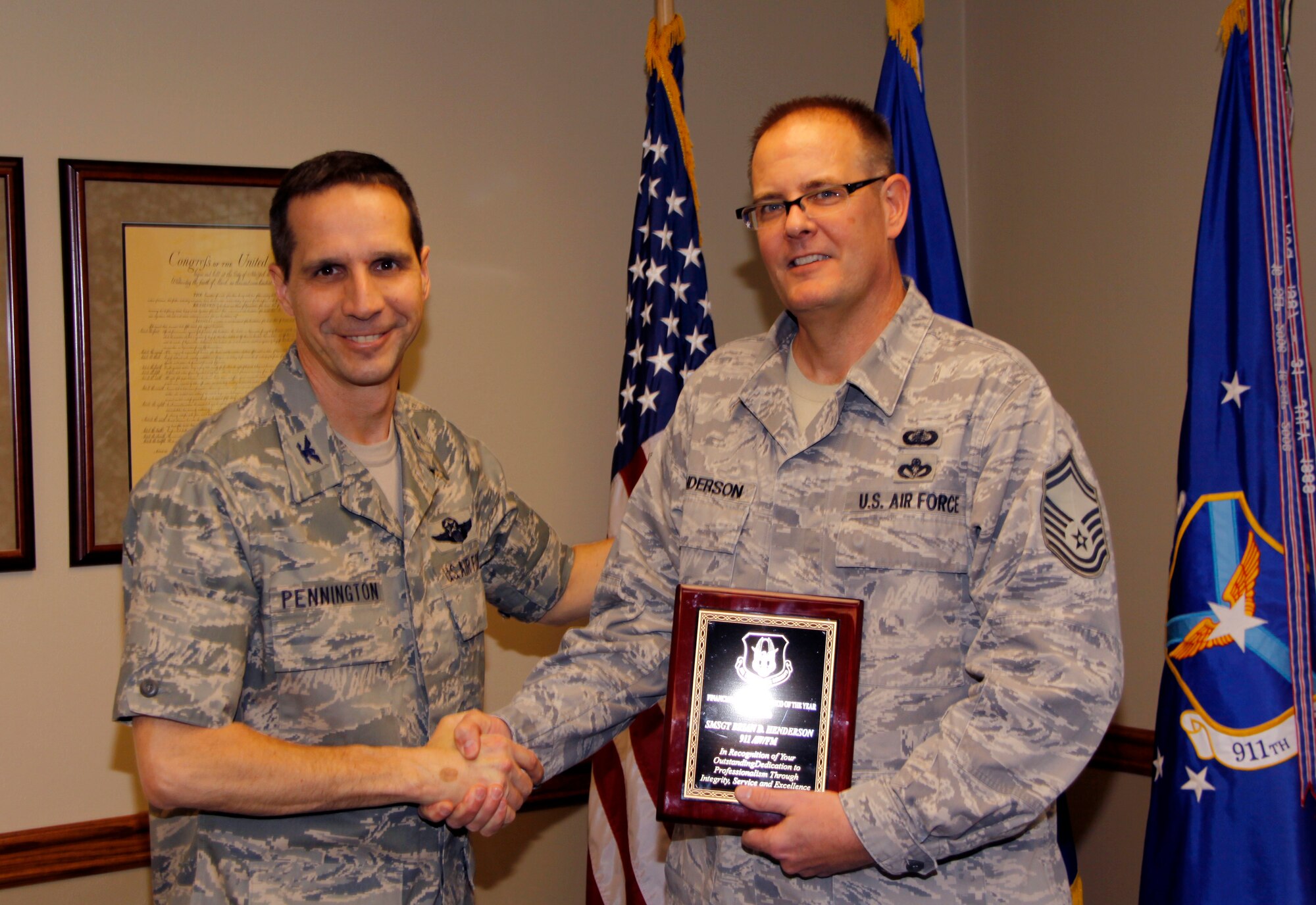 Senior Master Sgt. Brian D. Henderson, 911th Airlift Wing financial management comptroller, is  congratulated by Col. Jeffrey Pennington, 911 AW commander, for being awarded the Financial Management Senior Noncommissioned Officer of the Year 2010. (U.S. Air Force photo/Senior Airman Jonathan Hehnly)