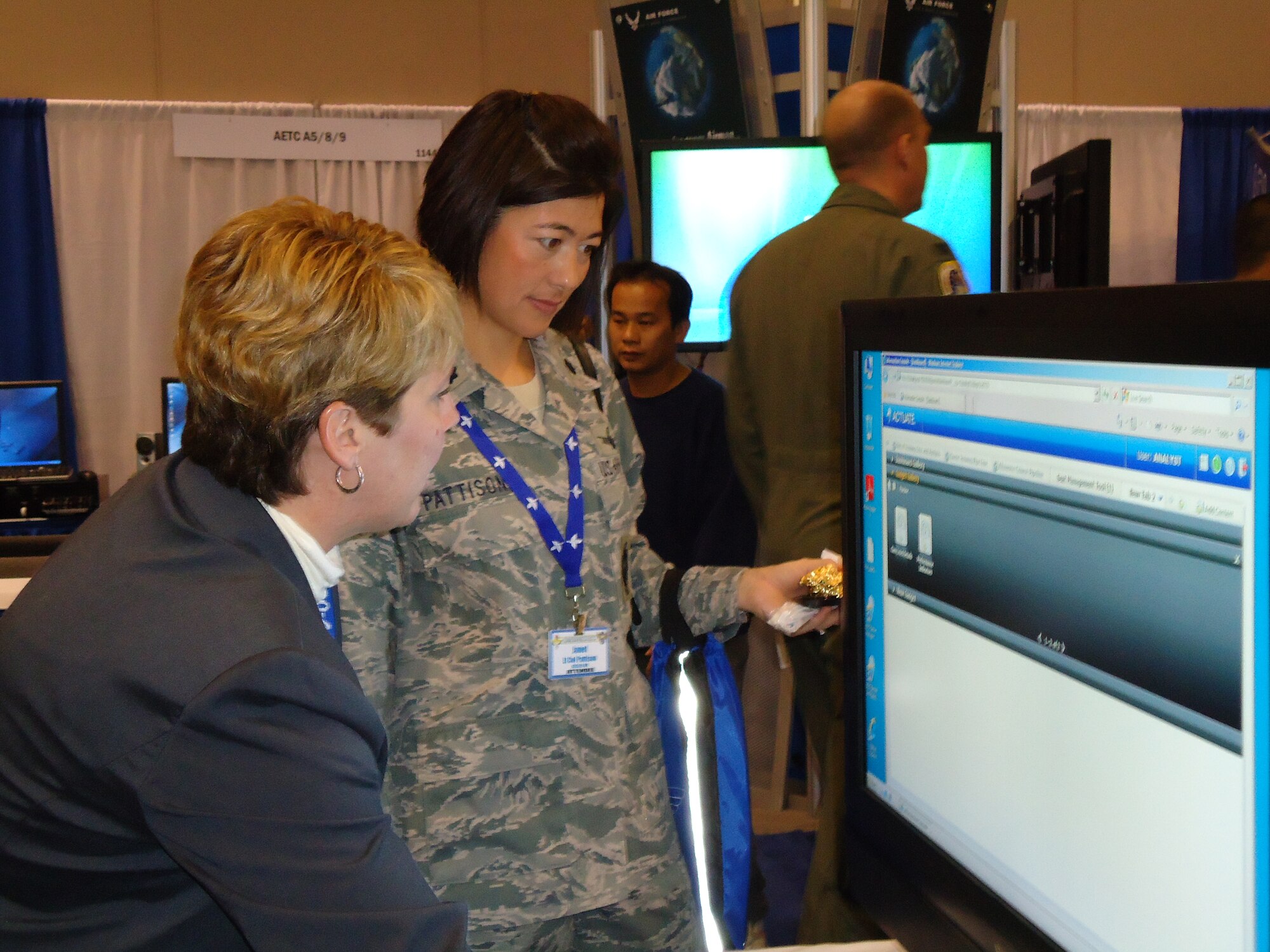 Joanne Baquero, left, demonstrates 2nd Air Force’s training continuum digital dashboard to Lt. Col. Janet Pattison, 81st Training Support Squadron commander. The digital dashboard, part of the Technical Training Management System, eliminates many data-crunching manhours in tracking the status of students in training.  (U.S. Air Force photo by Susan Griggs)