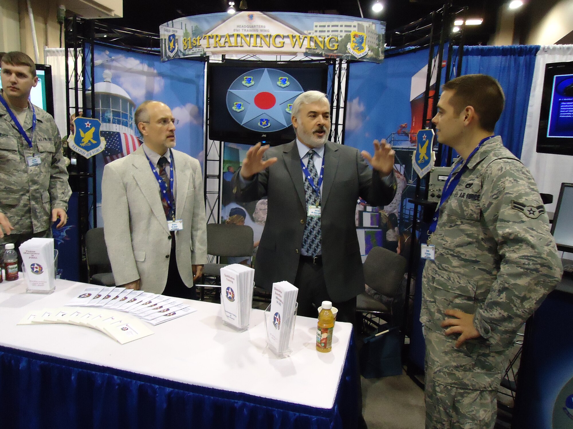 From left, Barry Davis and Jesse Cheeseman, 81st TRSS, talk to Airman 1st Class Sean Medlin about training innovations at Keesler. Airman Medlin is from Tyndall Air Force Base, Fla.  (U.S. Air Force photo by Susan Griggs)