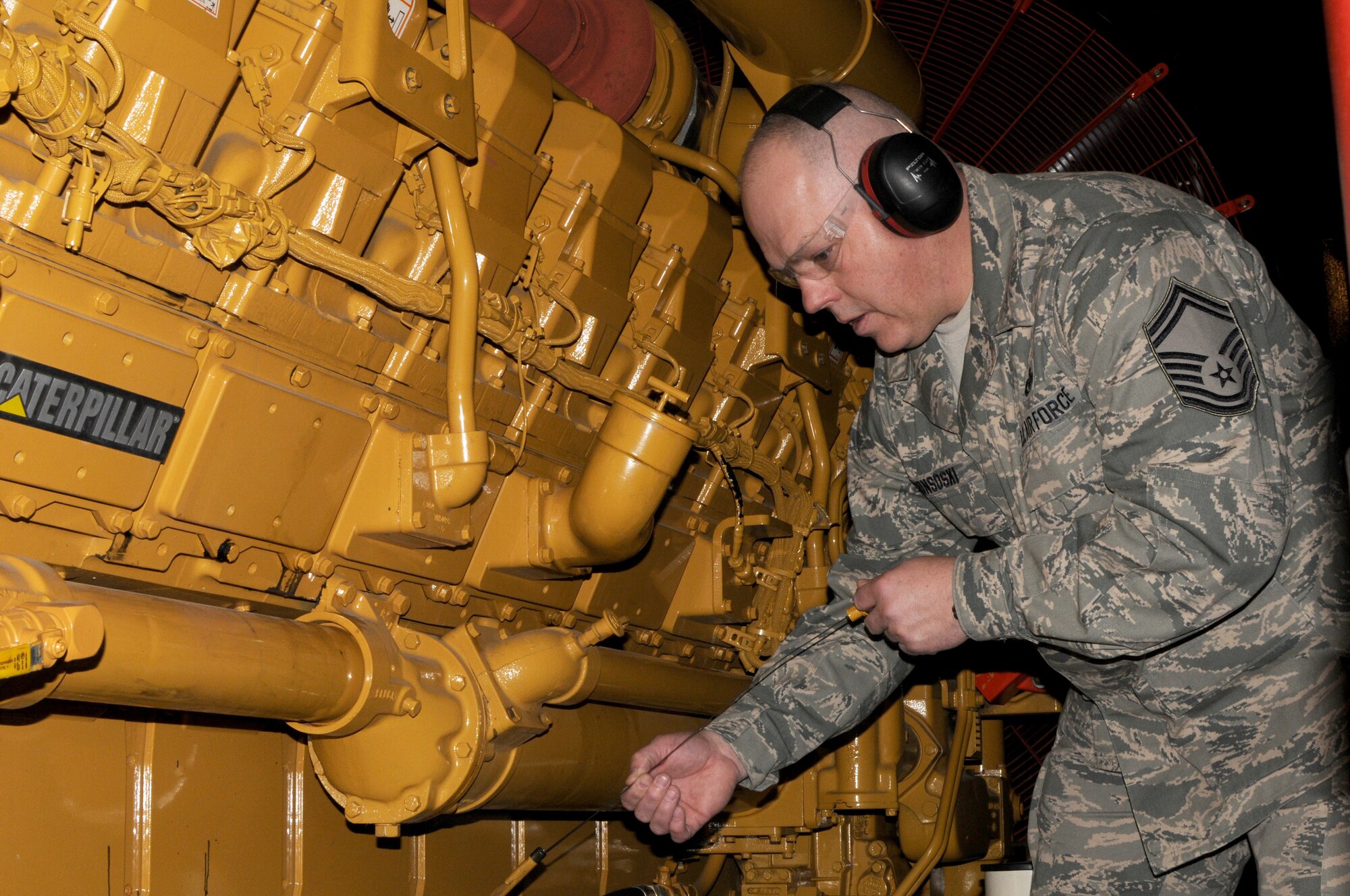 Senior Master Sgt. Dave Gonsoski, superintendant of the power production shop at the 133rd Civil Engineer Squadron, checks oil levels in the base generator Jan. 23, 2010 on the Air National Guard Base in St. Paul, Minn. Gonsoski has been selected as the Minnesota Air Guard Outstanding honor guard member for 2011. USAF official photo by Tech. Sgt. Erik Gudmundson