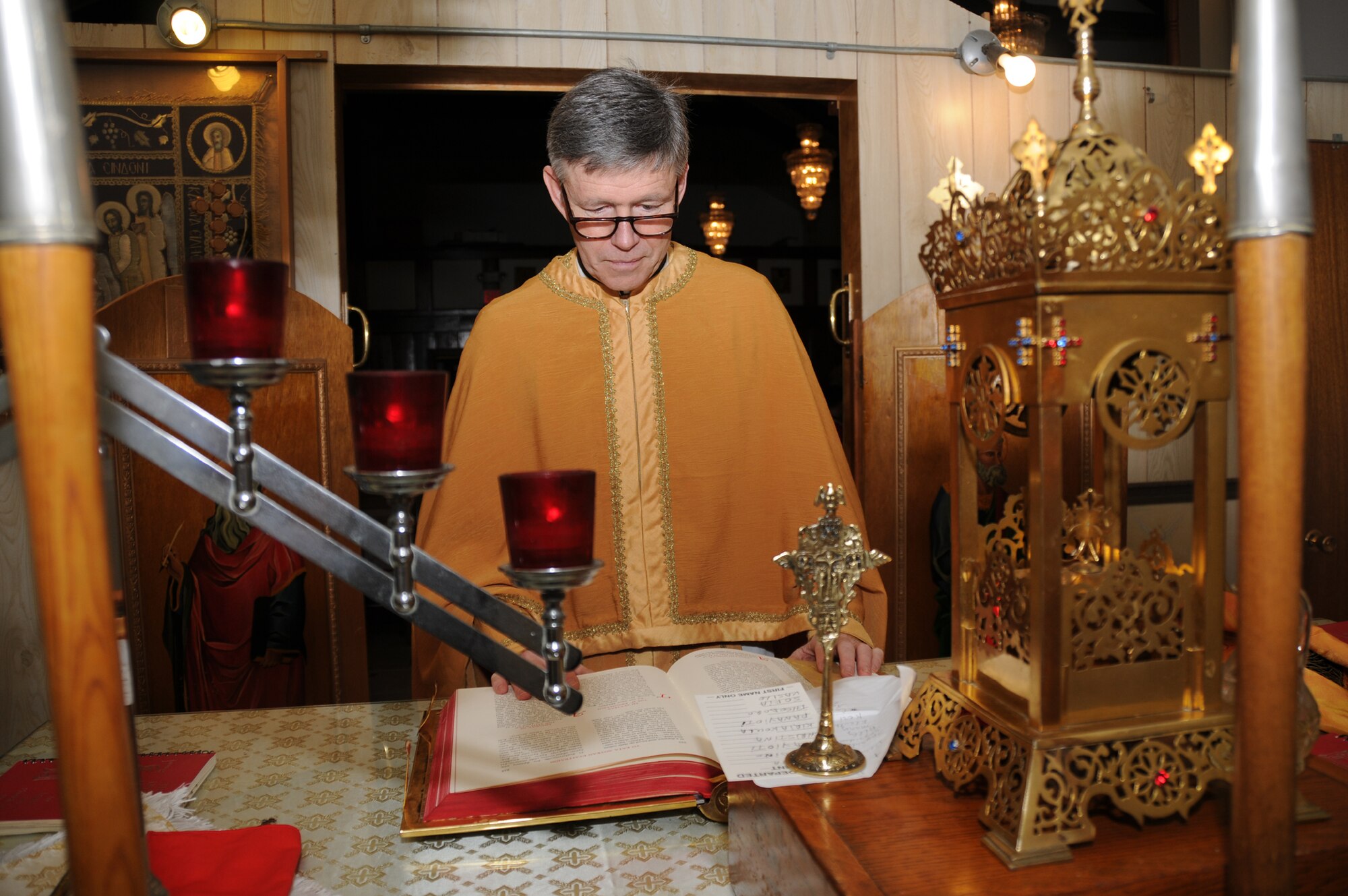 Surrounded by icons, candles and incense, Father Stefan Close, aka Chaplain Henry Close, prepares to read the Gospel at Holy Trinity Greek Orthodox Church in Biloxi
where he serves as priest. (U.S. Air Force photo by Kemberly Groue)