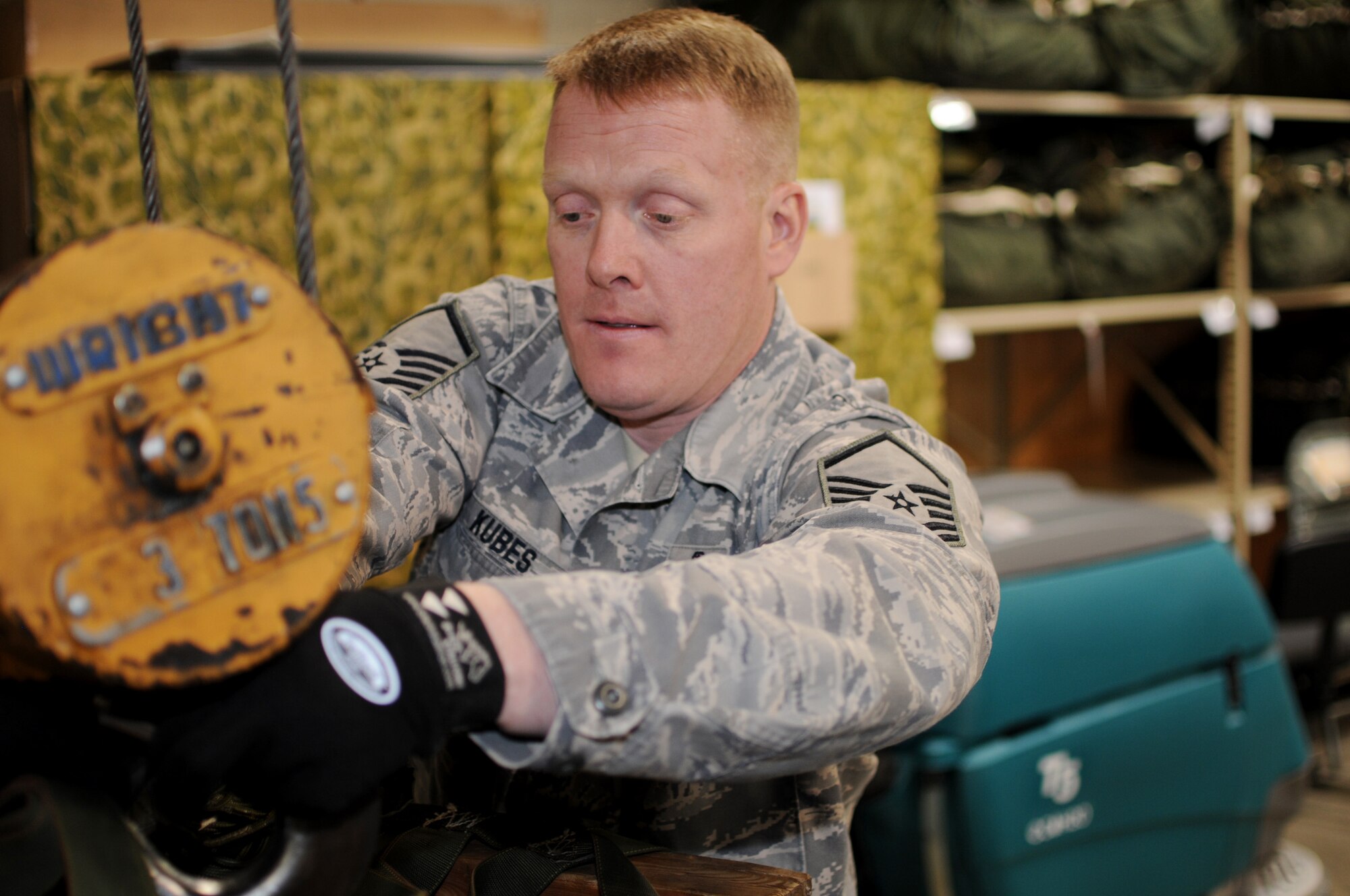 Master Sgt. John Kubes, superintendent of the small air terminal at the 133rd Logistics Readiness Squadron, hooks an airdrop pallet to a hoist to lift it into position on Jan. 22, 2010 on the Air National Guard Base in St. Paul, Minn. Kubes has been selected to represent Minnesota as the Air Guard Outstanding Senior NCO for 2011. USAF official photo by Tech. Sgt. John Wiggins