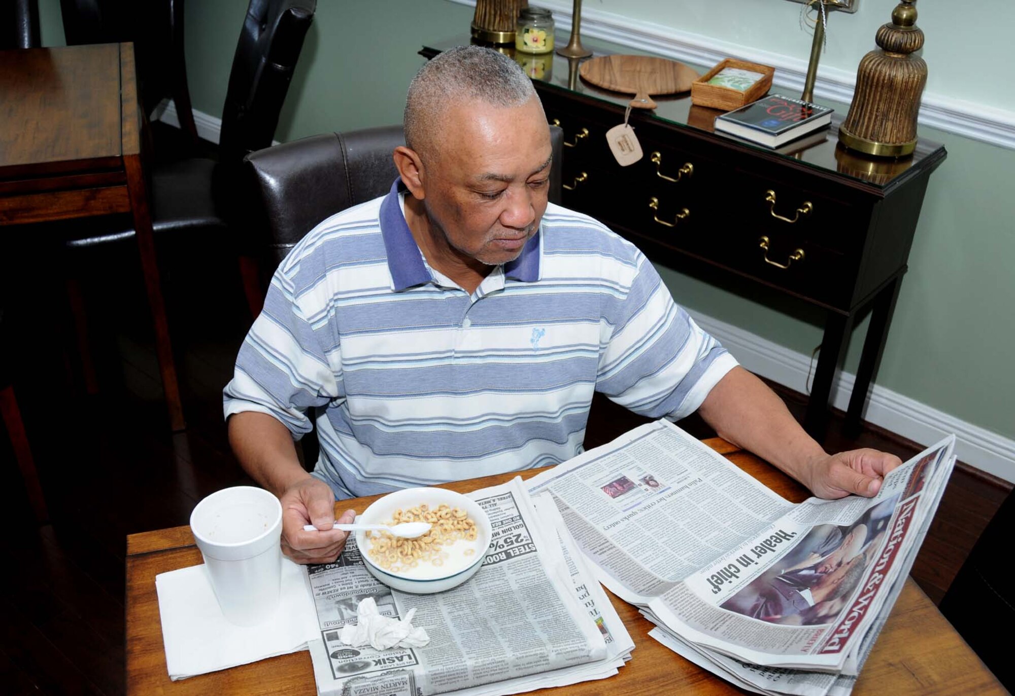 Otis Hall, an Army veteran from Pensacola, Fla., eats his cereal, reads the morning newspaper and enjoys the comforts that the Fisher House provides while he receives his medical treatment.  (U.S. Air Force photo by Kemberly Groue)