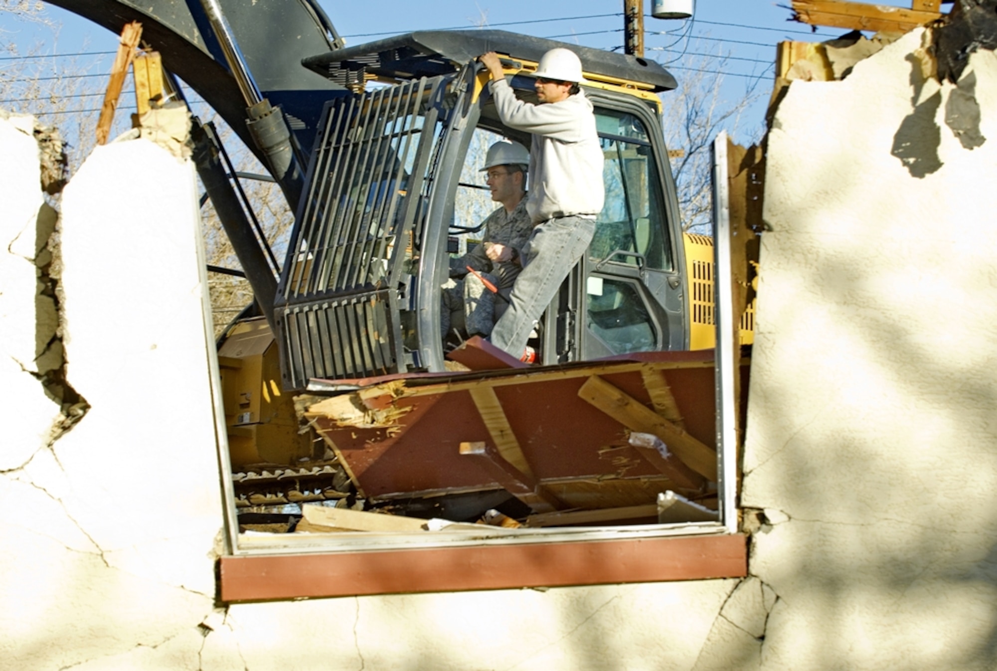Col. Gregory Schwab, 95th Air Base Wing commander, takes part in a ceremony commencing the demolition of one of the final sections of old base housing. (Air Force Photo by Rob Densmore)