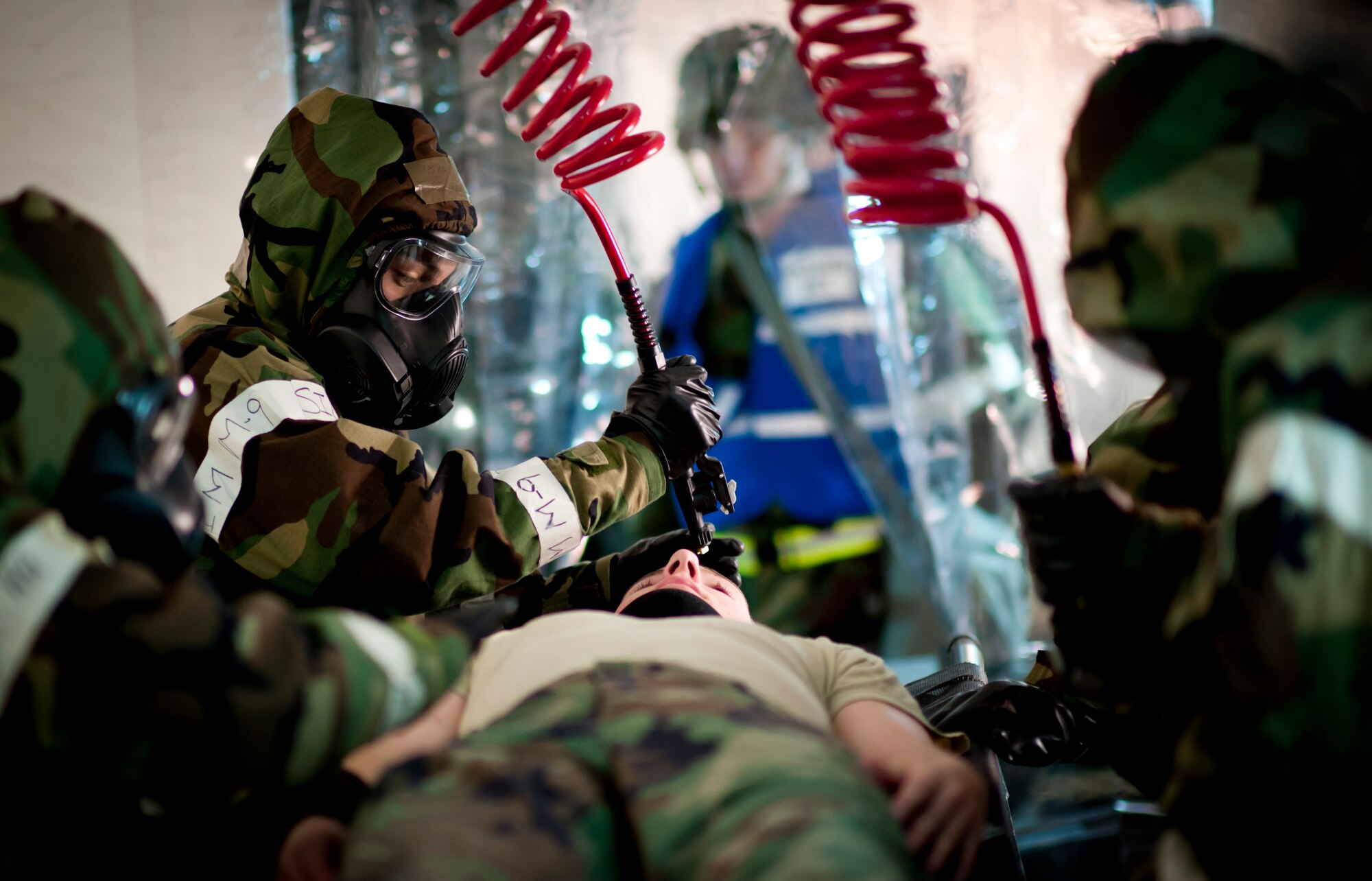 Airmen from the 35th Medical Group decontaminate a patient while in a simulated deployed environment during an operational readiness exercise at Misawa Air Base, Japan, Jan. 26, 2011. Patients wounded in a chemical environment must be decontaminated before medics can treat any injuries. (U.S. Air Force photo by Staff Sgt. Samuel Morse/Released)