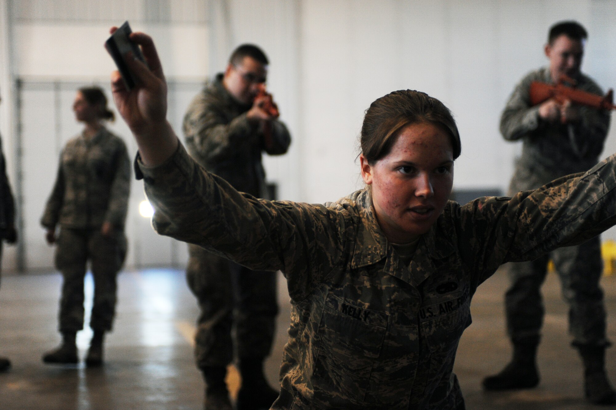 MINOT AIR FORCE BASE, N.D. -- Airman 1st Class Coleen Kelly, 5th Maintenance Squadron aircraft structural maintainer, is detained as part of the Ability to Survive and Operate training here Jan. 19.  During ATSO training, Airmen learn the basics of detaining enemies, self aid buddy care, different types of explosives, how to respond to a chemical attack and more. (U.S. Air Force photo/ Airman 1st Class Aaron- Forrest Wainwright)