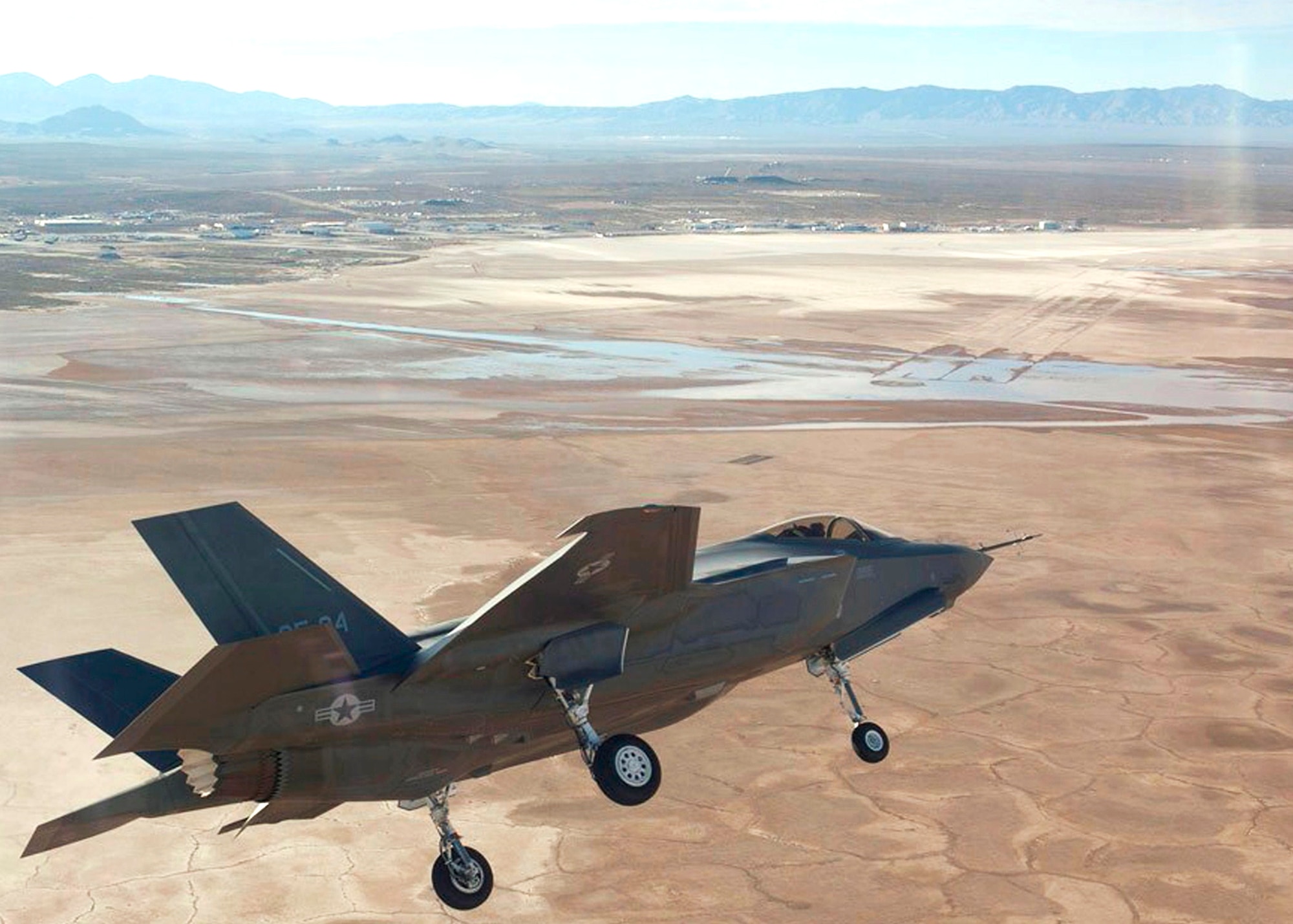 F-35 Joint Strike Fighter AF-04 banks toward base as it arrives at Edwards Jan. 22. During its time here, the flight science aircraft will perform various structure tests including high-angle-of-attack and air-start tests. The JSF is a joint, multinational acquisition program for the Air Force, Navy, Marine Corps, and eight cooperative international partners. The JSF aircraft design has three variants: conventional takeoff and landing variant for the Air Force, aircraft carrier-suitable variant for the Navy, and short takeoff and vertical landing variant for the Marine Corps, the United Kingdom, and the Air Force. This is the fourth F-35 Lightning II to arrive at Edwards since last summer.