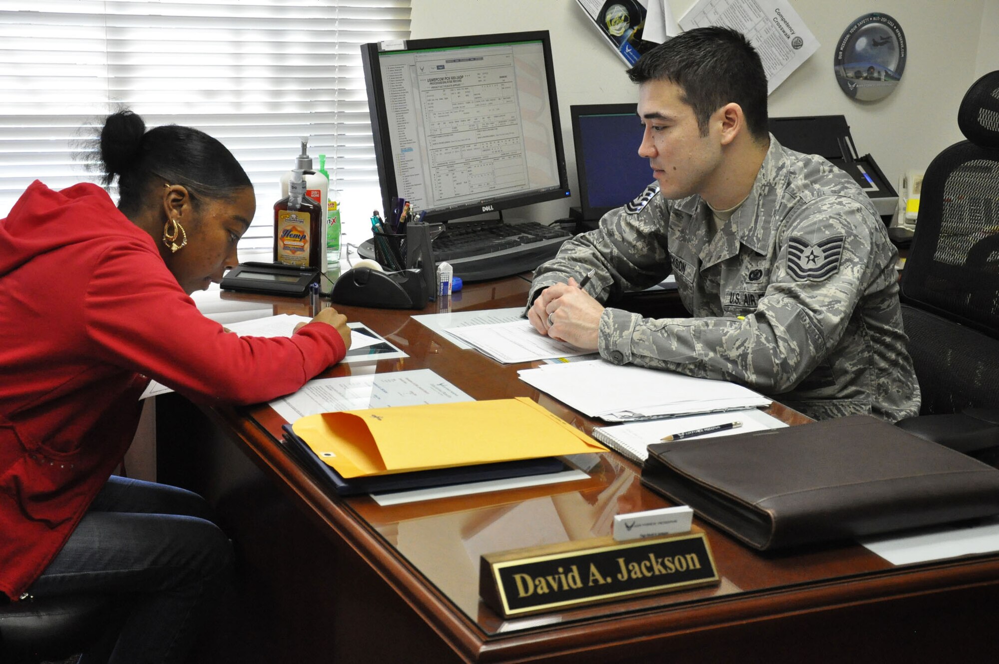 Tech. Sgt. David A. Jackson, a line-recruiter with the 315th Airlift Wing, Joint Base Charleston, S.C. supervises Fakeyma N. Williams, an Air Force Reserve applicant from Savannah, Ga., as she completes her initial interview paperwork here to start the qualification process of becoming an airman Jan. 26, 2011. (U.S. Air Force photo/Senior Airman Robert Pilch)