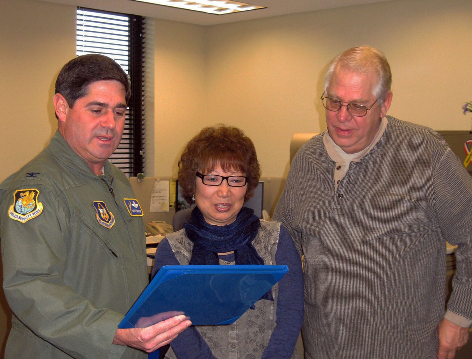 TRAVIS AIR FORCE BASE, Calif. -- The 349th Air Mobility Wing says a fond farewell to Ms. Judy P. Linander, 349th Financial Management, after 25 years of faithful and devoted Federal Civilian Service, Jan. 25. Her husband, Duane, was also here and received a certification of appreciation presented by Col. Barrett  Broussard, 349th AMW Vice Commander. (U.S. Air Force photo/Patti Schwab-Holloway)