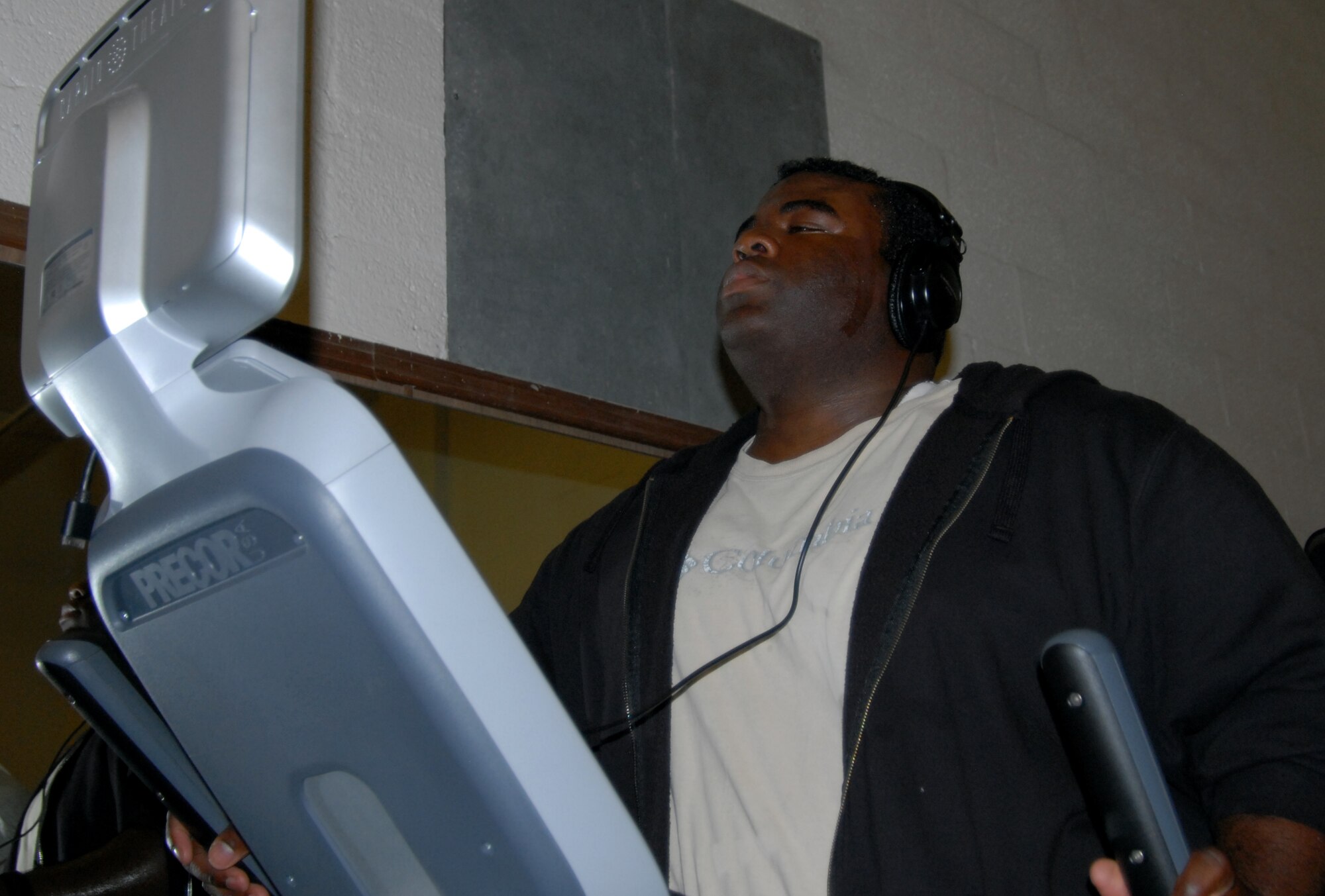 Christopher Coleman, 812th Test Support Squadron engineering test techniques BFTF data manager, gets fit on the elliptical machine in the Rosburg Fitness Center as part of his participation in the Run the Coast of California Incentive Program. (Air Force photo by Kate Blais)