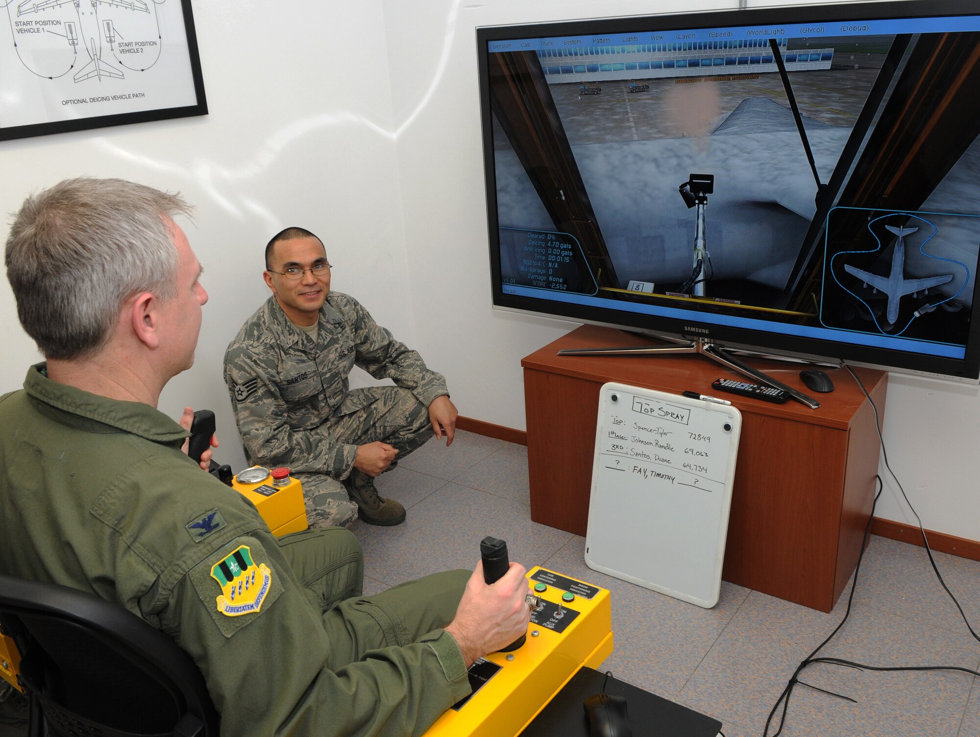 SPANGDAHLEM AIR BASE, Germany – Col. Timothy Fay, 2nd Bomb Wing commander from Barksdale Air Force Base, La., uses the 726th Air Mobility Squadron’s de-icing simulator during a demonstration by Staff Sgt. Duane Santos, 726th AMS maintenance training monitor, during a briefing for the Air Force’s Installation Excellence and Special Recognition Award here Jan. 26. Spangdahlem AB is competing against Travis Air Force Base, Calif., for this year’s IEA. The base that wins will receive $1 million to increase quality of life. (U.S. Air Force photo/Airman 1st Class Matthew B. Fredericks)