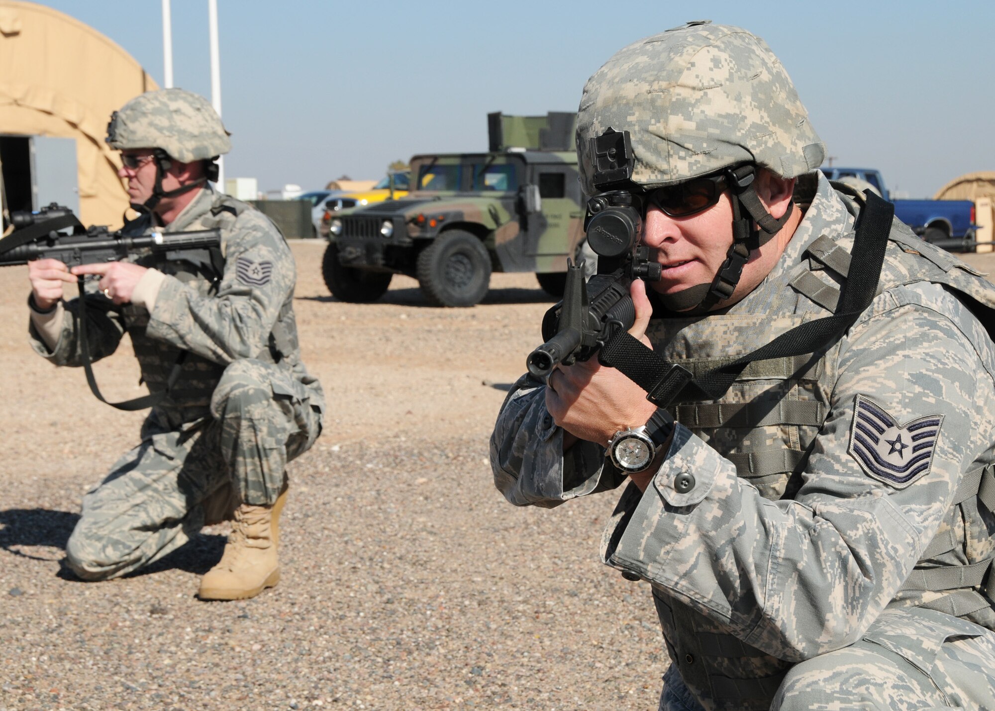 TSgt. Scott Tracy, 944th Security Forces (front), and TSgt. Robert Henry, 944th Security Forces (back) aim M-4 rifles while at the Ability To Survive and Operate area Jan. 8 during the unit training assembly. (Photo taken by Staff Sgt. Louis Vega Jr., 944th Fighter Wing public affairs)