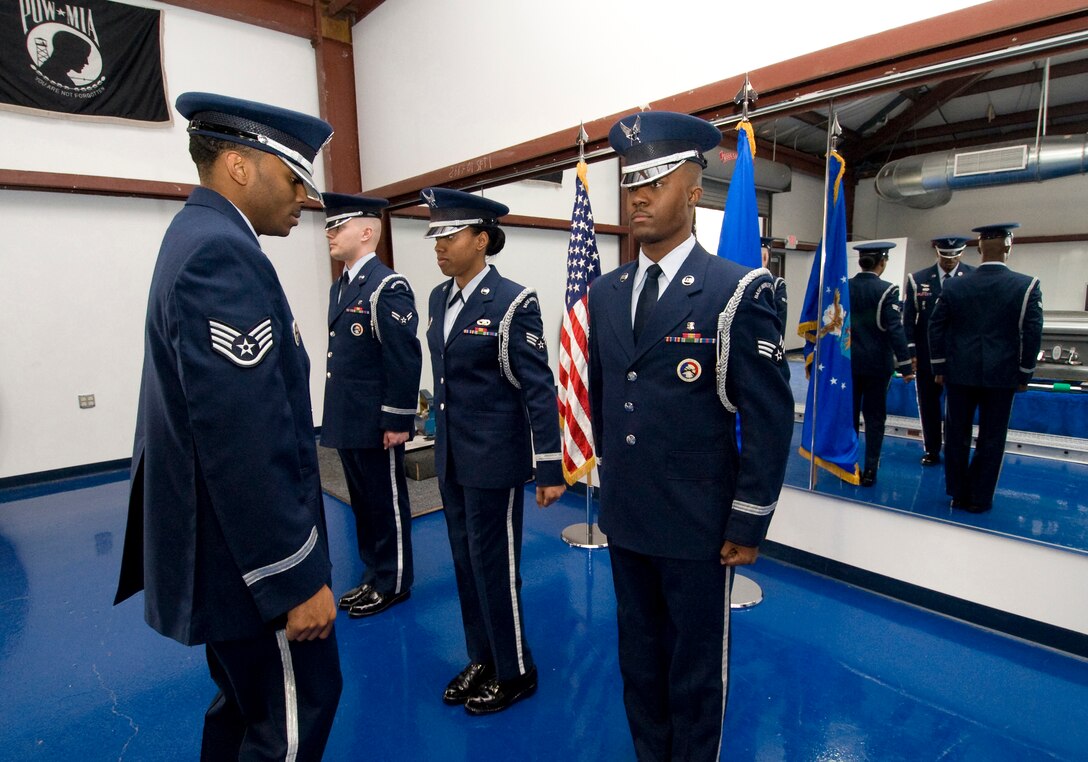 ANDREWS AIR FORCE BASE, Md. – Staff Sgt.  Karl Bell, left, 11th Force Support Squadron ceremonial guardsman, performs a uniform inspection prior to an upcoming retirement ceremony Jan. 19.  (U.S. Air Force photo/Bobby Jones)