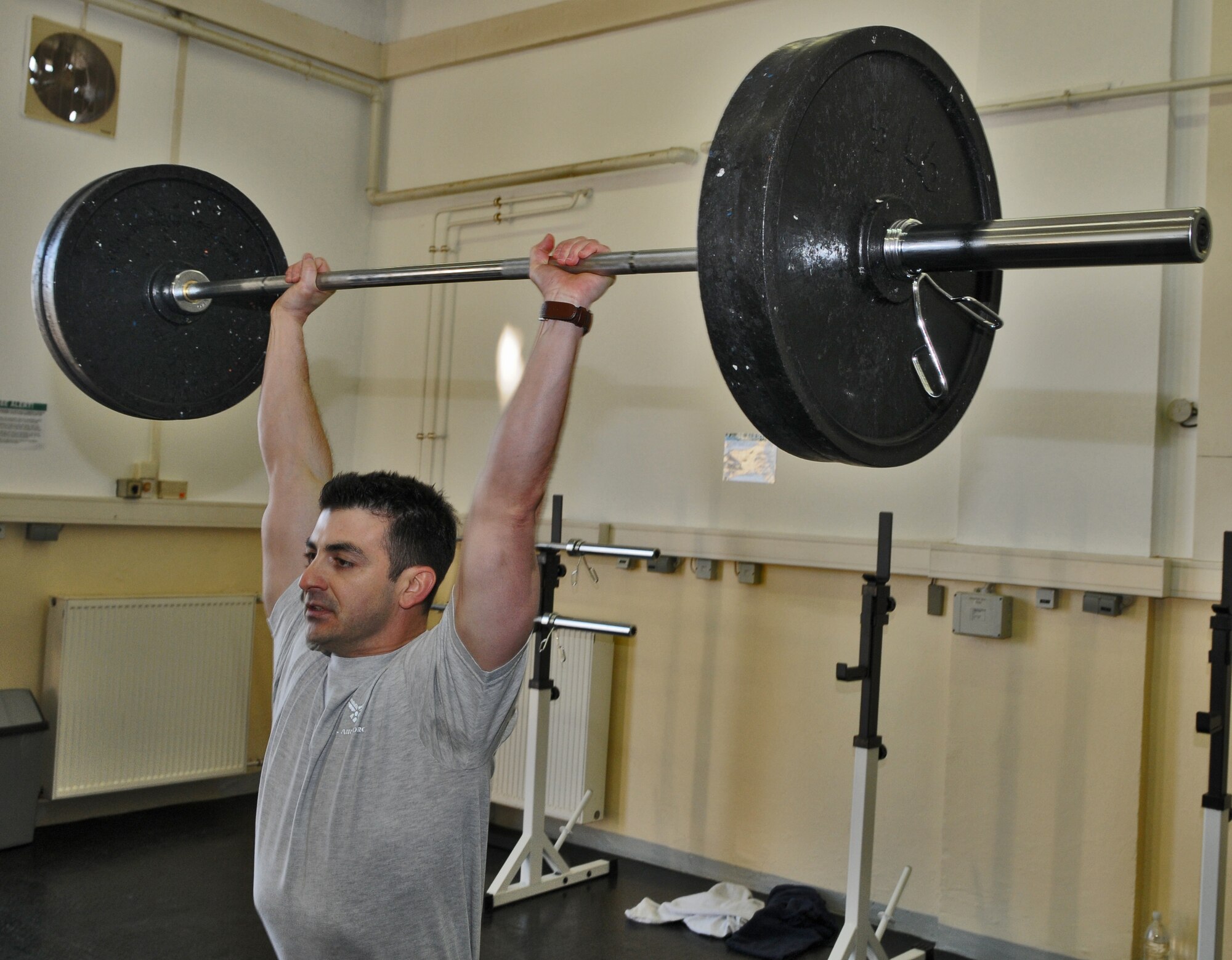 SPANGDAHLEM AIR BASE, Germany – Staff Sgt. Christopher Johnson, 52nd Communications Squadron physical training leader and CrossFit fitness specialist, demonstrates the proper technique for a push press during the grand opening of the 52nd Force Support Squadron’s combat fitness facility here Jan. 21. The new combat fitness facility will open to squadrons for individual and unit physical training in February. Trained physical training leaders will incorporate CrossFit exercises into unit programs. (U.S. Air Force photo/Senior Airman Nick Wilson)