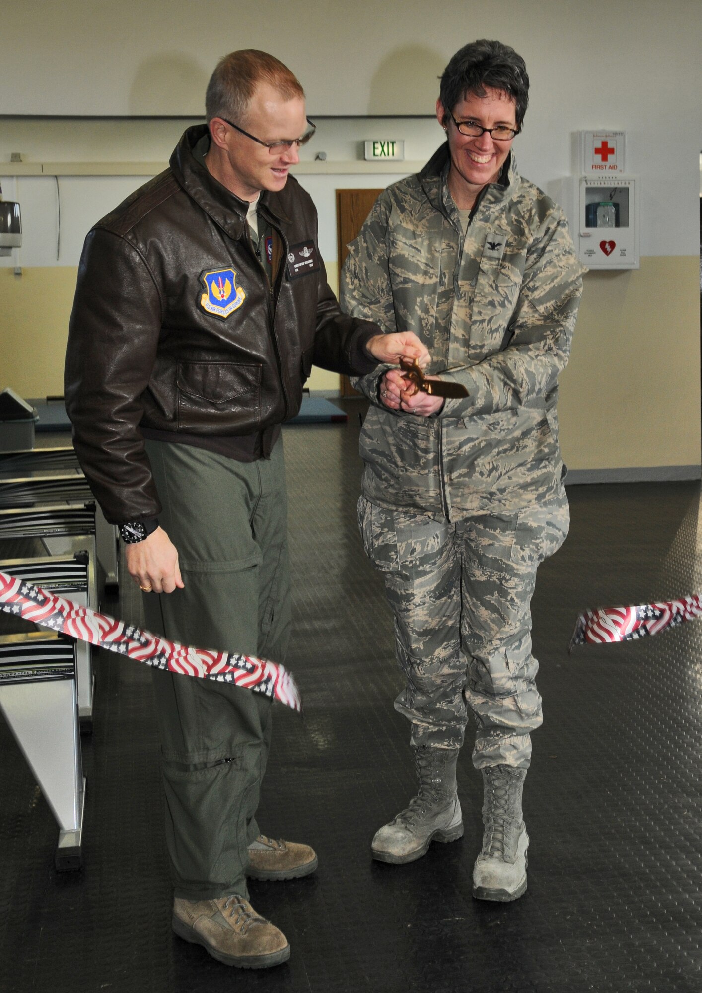 SPANGDAHLEM AIR BASE, Germany – Col. Christopher Weggeman, 52nd Fighter Wing commander, and Col. Jodine Tooke, 52nd Mission Support Group commander, cut the ribbon during the grand opening of the 52nd Force Support Squadron’s combat fitness facility here Jan. 21. The new combat fitness facility will open to squadrons for individual and unit physical training in February. Trained physical training leaders will incorporate CrossFit exercises into unit programs. (U.S. Air Force photo/Senior Airman Nick Wilson)