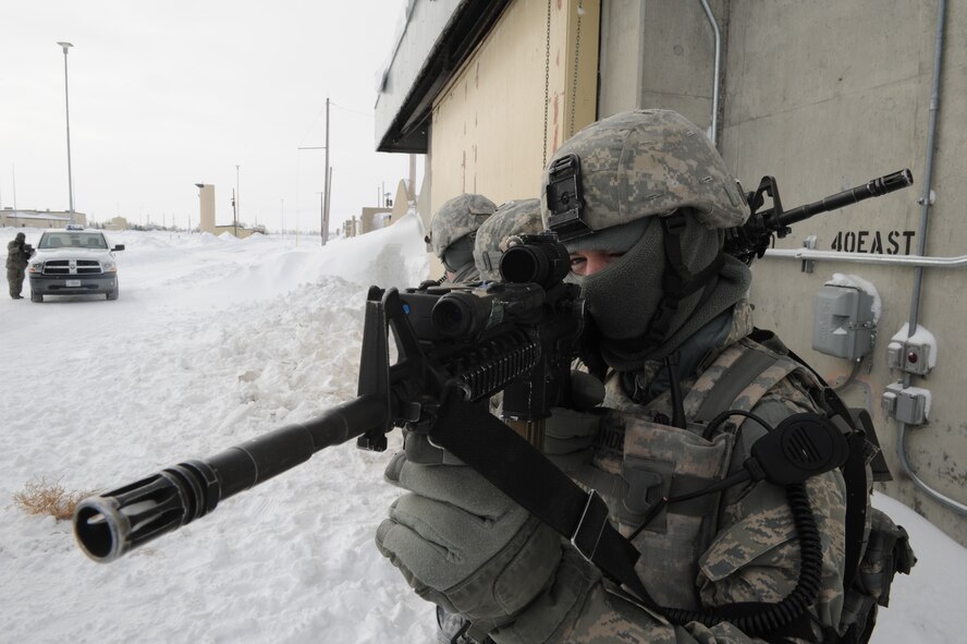 MINOT AIR FORCE BASE, N.D. -- Airman 1st Class Nathan Anderline, 5th Security Forces Squadron response force team member, lines up his sights during a training scenario at the weapons storage area here Jan. 24. Training like this helps the 5th SFS “Defenders” keep their combat skills sharp. (U.S. Air Force photo/Senior Airman Michael J. Veloz)