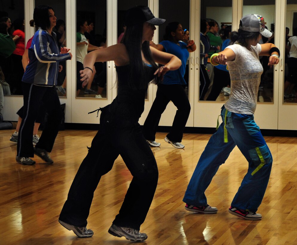 Airmen and their families attend a Zumba dance fitness demonstration during the 2011 Wellness Expo at Ellsworth Air Force Base, S.D., Jan. 22.  Airmen, their families and friends had the opportunity to visit with different vendors from the Black Hills region during the expo that focused on staying fit and keeping healthy. (U.S. Air Force photo/Senior Airman Anthony Sanchelli)