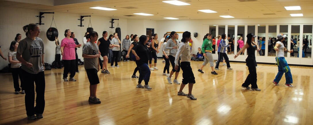 Airmen and their families attend a Zumba dance fitness demonstration during the 2011 Wellness Expo at Ellsworth Air Force Base, S.D., Jan. 22.  Airmen, their families and friends had the opportunity to visit with vendors from the surrounding area, during the expo that focused on staying fit and keeping healthy. (U.S. Air Force photo/Senior Airman Anthony Sanchelli)