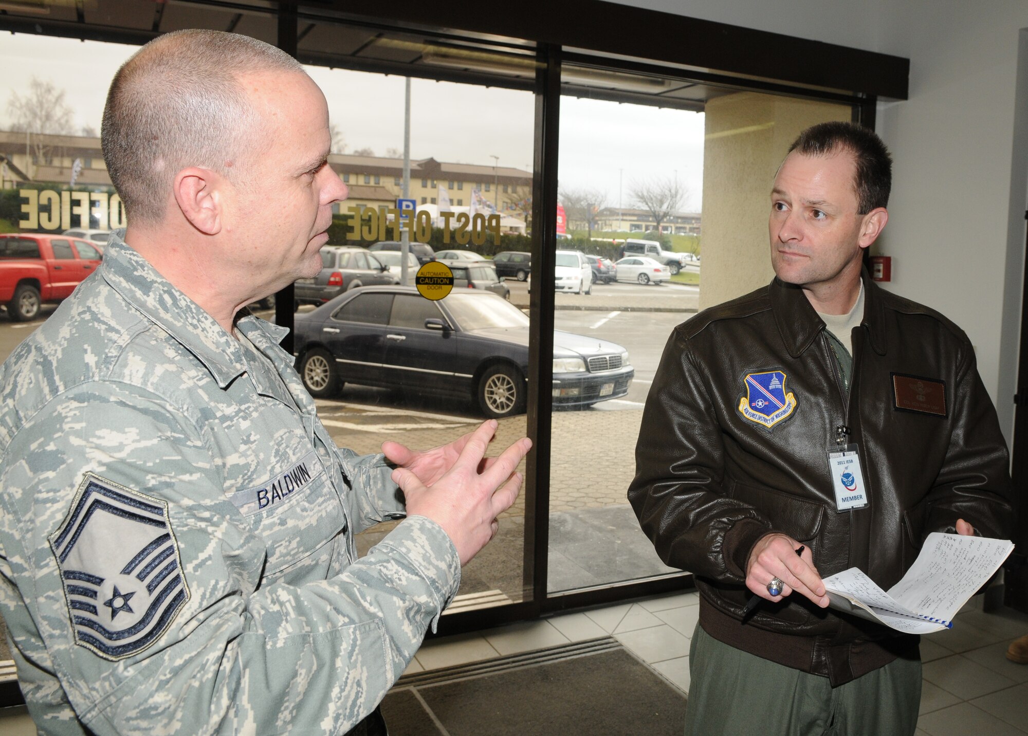 SPANGDAHLEM AIR BASE, Germany – Senior Master Sgt. Kirk Baldwin, 52nd Communications Squadron postal operations superintendant, speaks to Col. Kenneth R. Rizer, 11th Wing commander from Joint Base Andrews, Md., about postal operations here Jan. 26 in the post office. Colonel Rizer visited the base as part of an Installation Excellence Selection Board that visited the base to conduct a two-day evaluation to determine the Air Force's Installation Excellence and Special Recognition Award winners. Spangdahlem AB is competing against Travis Air Force Base, Calif., for this year's IEA. The base that wins receives $1 million to increase quality of life. (U.S. Air Force photo/Senior Airman Nick Wilson)