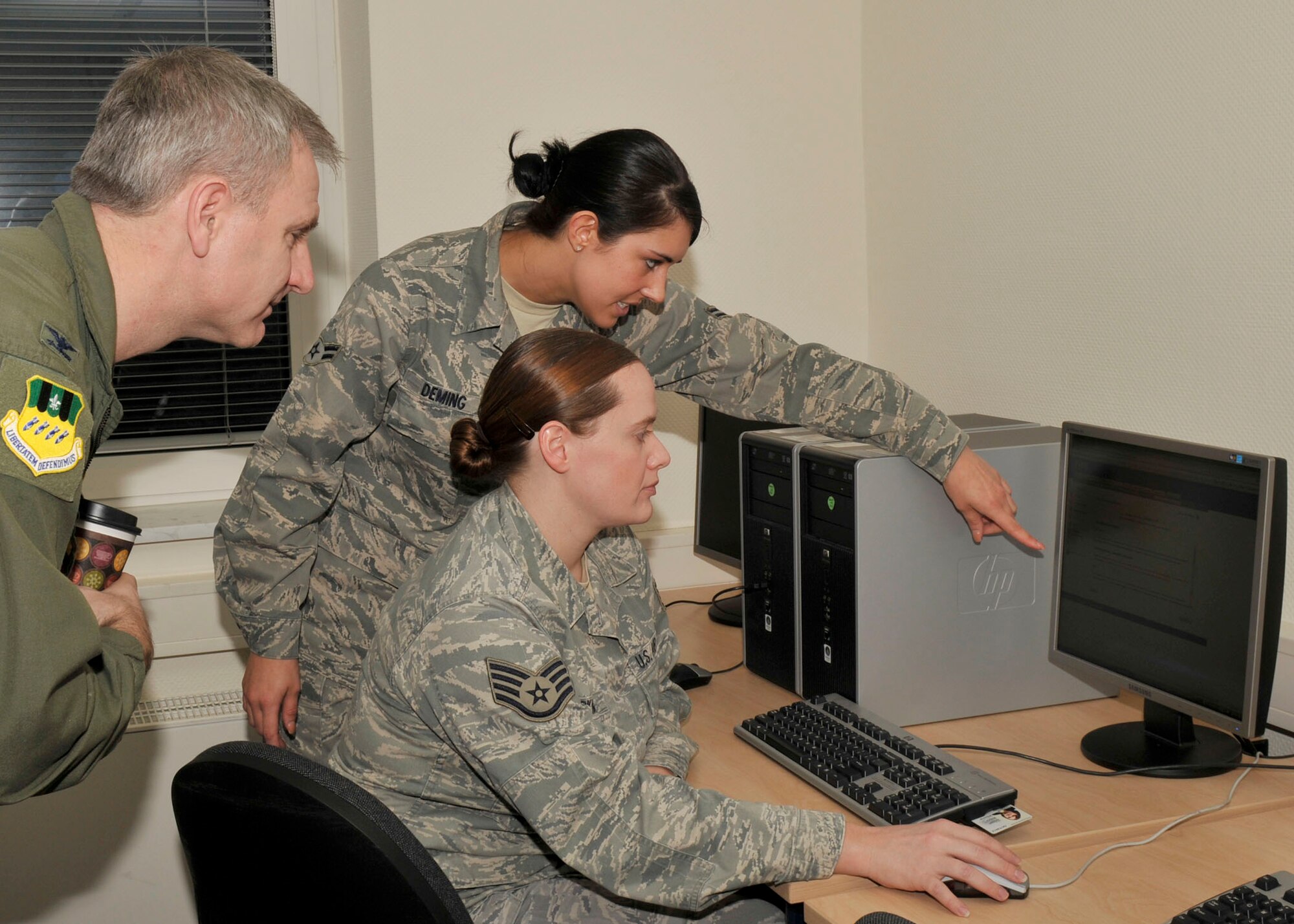 SPANGDAHLEM AIR BASE, Germany- Airman 1st Class Kristen Deming, 52nd Comptroller Squadron customer service technician, and Staff Sgt. Holly Parkman, 52nd Comptroller Squadron relocation technician, brief Col. Timothy Fay, Installation Excellence Selection Board member and 2nd Bomber Wing commander from Barksdale Air Force Base, La., on comptrollers and their roll here Jan. 26. The IEA selection board started their two-day evaluation of Spangdahlem Air Base and its award package Jan. 25. Spangdahlem AB is competing against Travis Air Force Base, Calif., for $1 million to improve quality of life. (U.S. Air Force photo/ Airman 1st Class Brittney Frees)