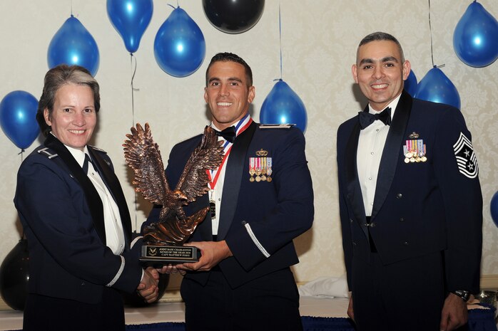 Col. Martha Meeker, left, and Chief Master Sgt. Jose LugoSantiago, right, presents Capt. Matthew Foisy with the Senior Company Grade Officer of the Year award for 2010 during the annual awards banquet held at the Charleston Club Jan 20, 2010. Airmen, Sailors and civilians were presented with an award for their outstanding accomplishments from one of the 15 different categories recognized. Unable to attend the banquet due to deployment or other reasons was, from the 628th Mission Support Group, Noncommissioned Officer of the Year Staff Sgt. Akeem Parks; from the 628 MSG, Senior Noncommissioned Officer of the Year Master Sgt. Michael Patterson; from the 628 MSG, First Sergeant of the Year Master Sgt. Steven Hart; and from the Naval Weapons Station, Sailor of the Year Personnel Specialist 1st  Class Petty Officer James Long. Colonel Meeker is the Joint Base Charleston commander, Chief LugoSantiago is the 628th Air Base Wing command chief and Captain Foisy is from the 628 MSG. (U.S. Air Force photo/Tech. Sgt. Chrissy Best)