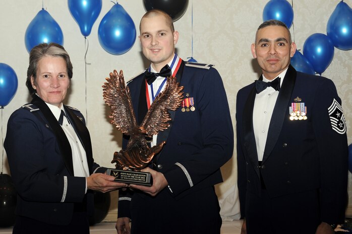 Col. Martha Meeker, left, and Chief Master Sgt. Jose LugoSantiago, right, presents 1st Lieutenant William Frechette with the Junior Company Grade Officer of the Year award for 2010 during the annual awards banquet held at the Charleston Club Jan 20, 2010. Airmen, Sailors and civilians were presented with an award for their outstanding accomplishments from one of the 15 different categories recognized. Unable to attend the banquet due to deployment or other reasons was, from the 628th Mission Support Group, Noncommissioned Officer of the Year Staff Sgt. Akeem Parks; from the 628 MSG, Senior Noncommissioned Officer of the Year Master Sgt. Michael Patterson; from the 628 MSG, First Sergeant of the Year Master Sgt. Steven Hart; and from the Naval Weapons Station, Sailor of the Year Personnel Specialist 1st  Class Petty Officer James Long. Colonel Meeker is the Joint Base Charleston commander, Chief LugoSantiago is the 628th Air Base Wing command chief and Lieutenant Frechette is from the 628th Medical Group. (U.S. Air Force photo/Tech. Sgt. Chrissy Best)